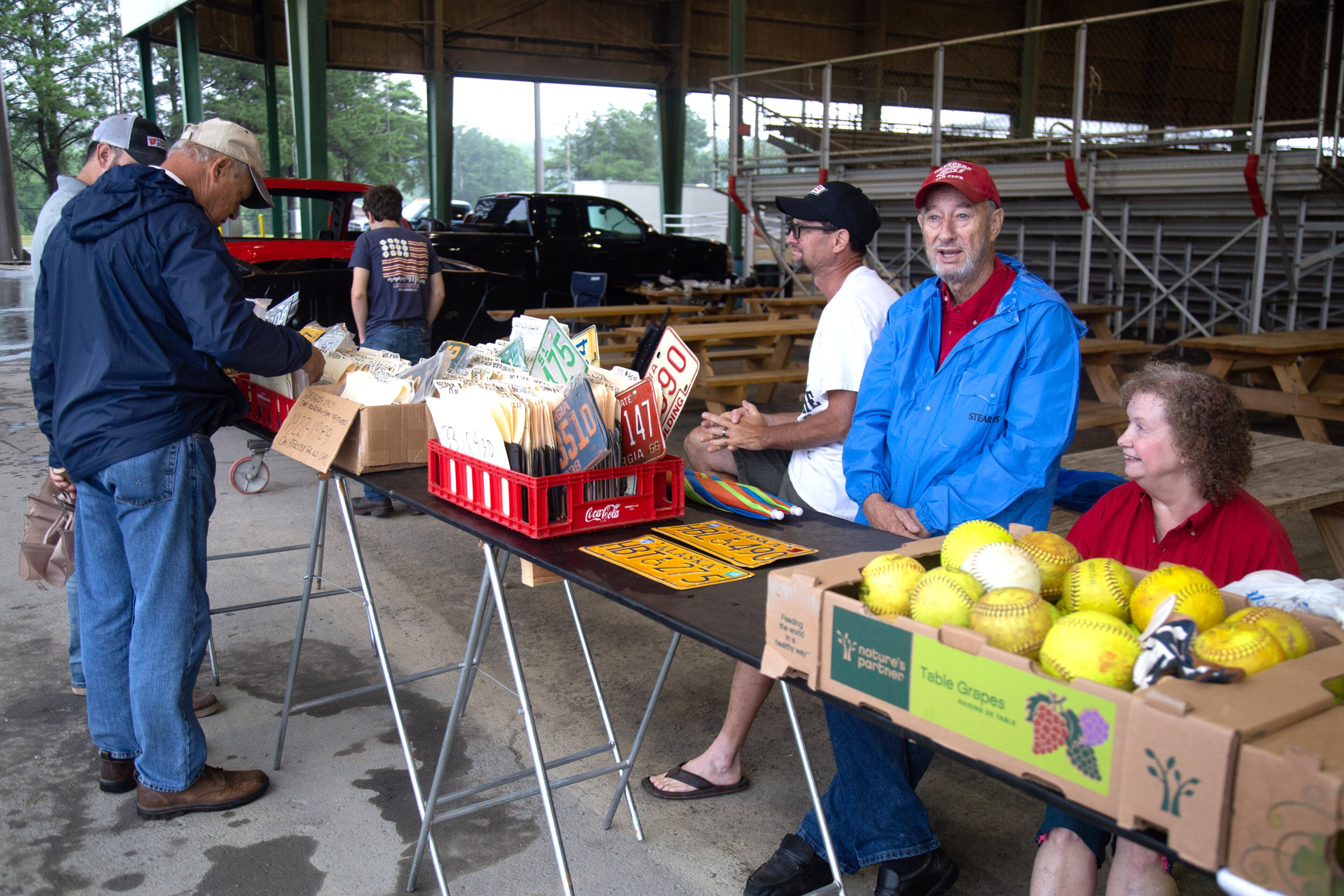 Jon Houze (L) sits next to his father, J.L. Houze and his Mother, Elaine Houze while selling old license plates at the Creepers Car Club’s 29th annual charity show in Marietta on Sunday, June 8, 2019. STEVE SCHAEFER / SPECIAL TO THE AJC