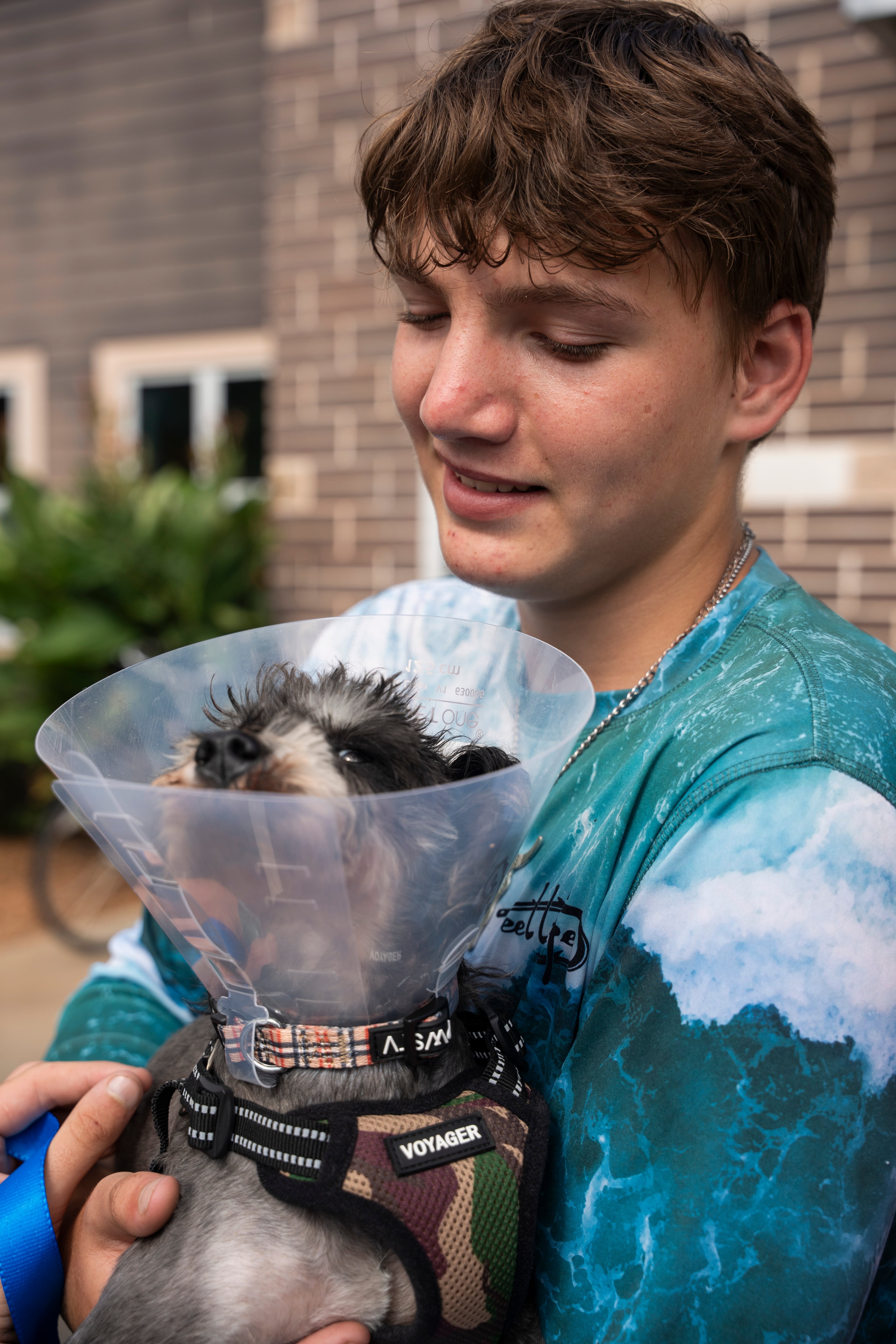 Kim Minshew and her foster son, Christopher (pictured), take a dog home from the DeKalb Animal Shelter on Tuesday, July 1, 2025, in Chamblee. Kim says dogs have worked better than therapy for Christopher, so they drove three hours to pick one out. (Olivia Bowdoin for the AJC)