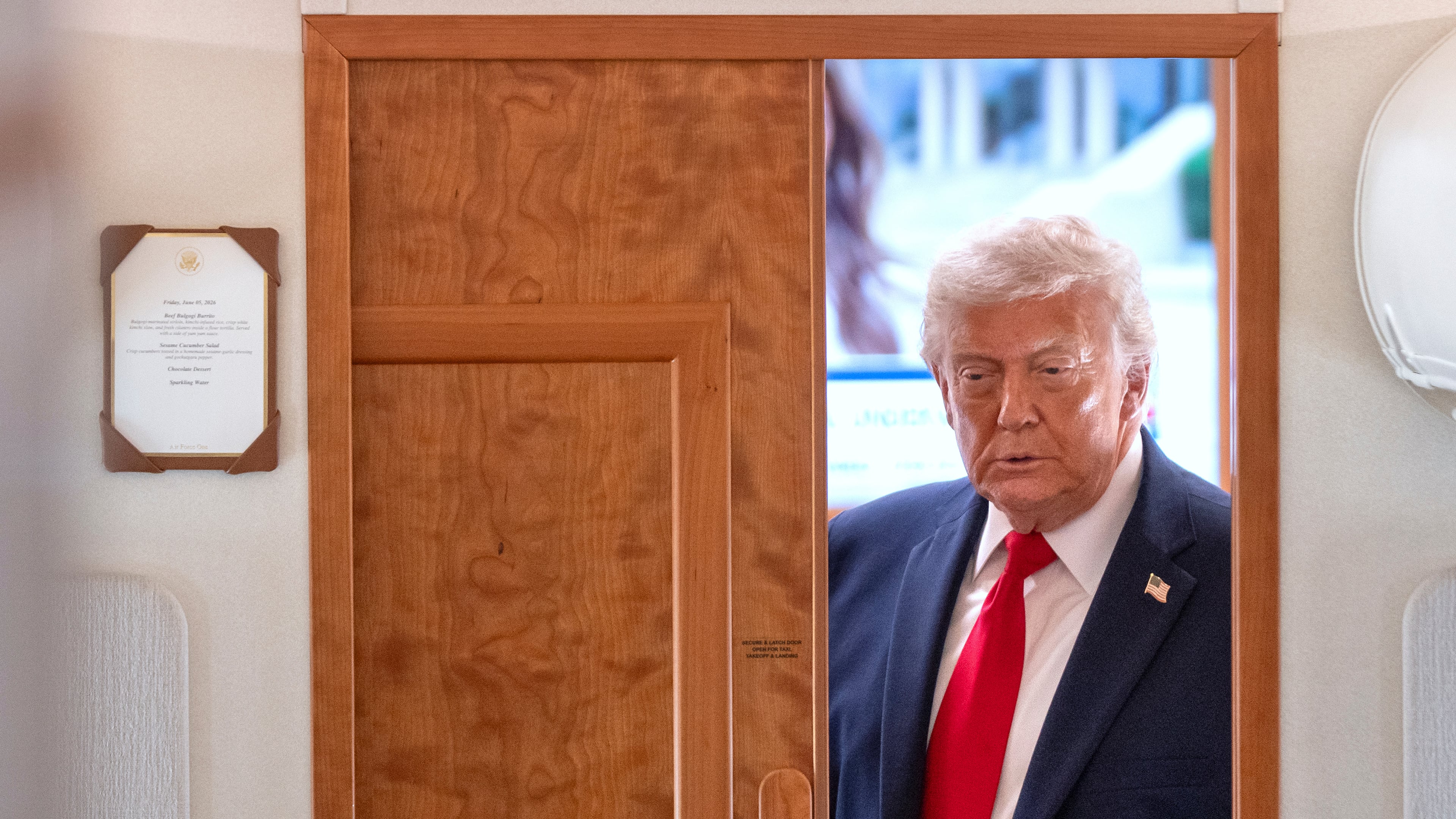 President Donald Trump arrives to speak to reporters aboard Air Force One en route from Joint Base Andrews, Md., to Eau Claire, Wis., Friday, June 5, 2026. (AP Photo/Mark Schiefelbein)