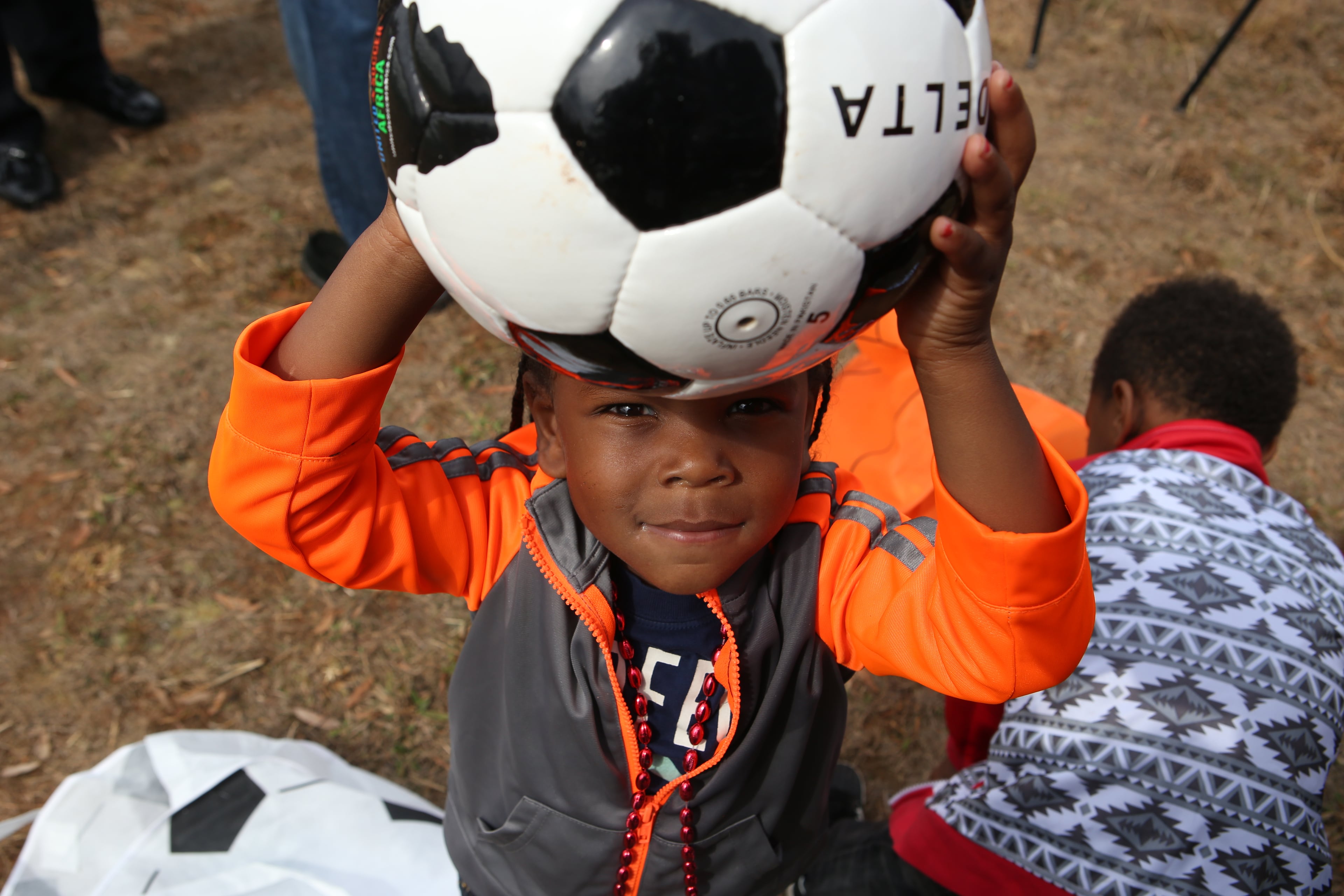 February 22, 2017, Atlanta, Georgia - Harley Chapman holds his new soccer ball up high in the sky after sitting through the long ordeal of unveiling the Atlanta Sports City sports complex site in Stonecrest, Georgia, on Wednesday, February 22, 2017. (HENRY TAYLOR / HENRY.TAYLOR@AJC.COM)