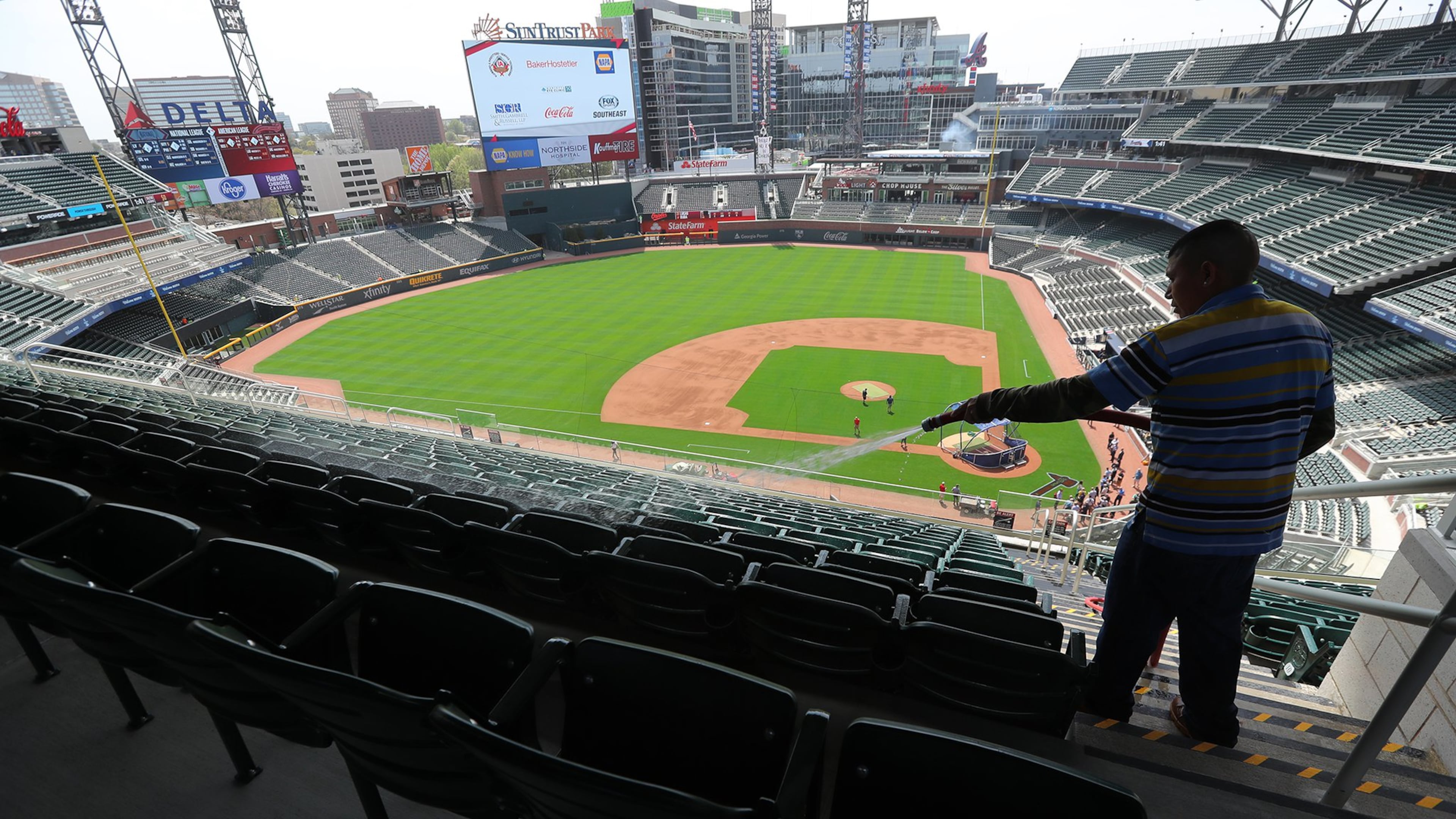 Seats were cleaned at SunTrust Park on Thursday for Friday night’s exhibition game against the Yankees. (Curtis Compton/ccompton@ajc.com)