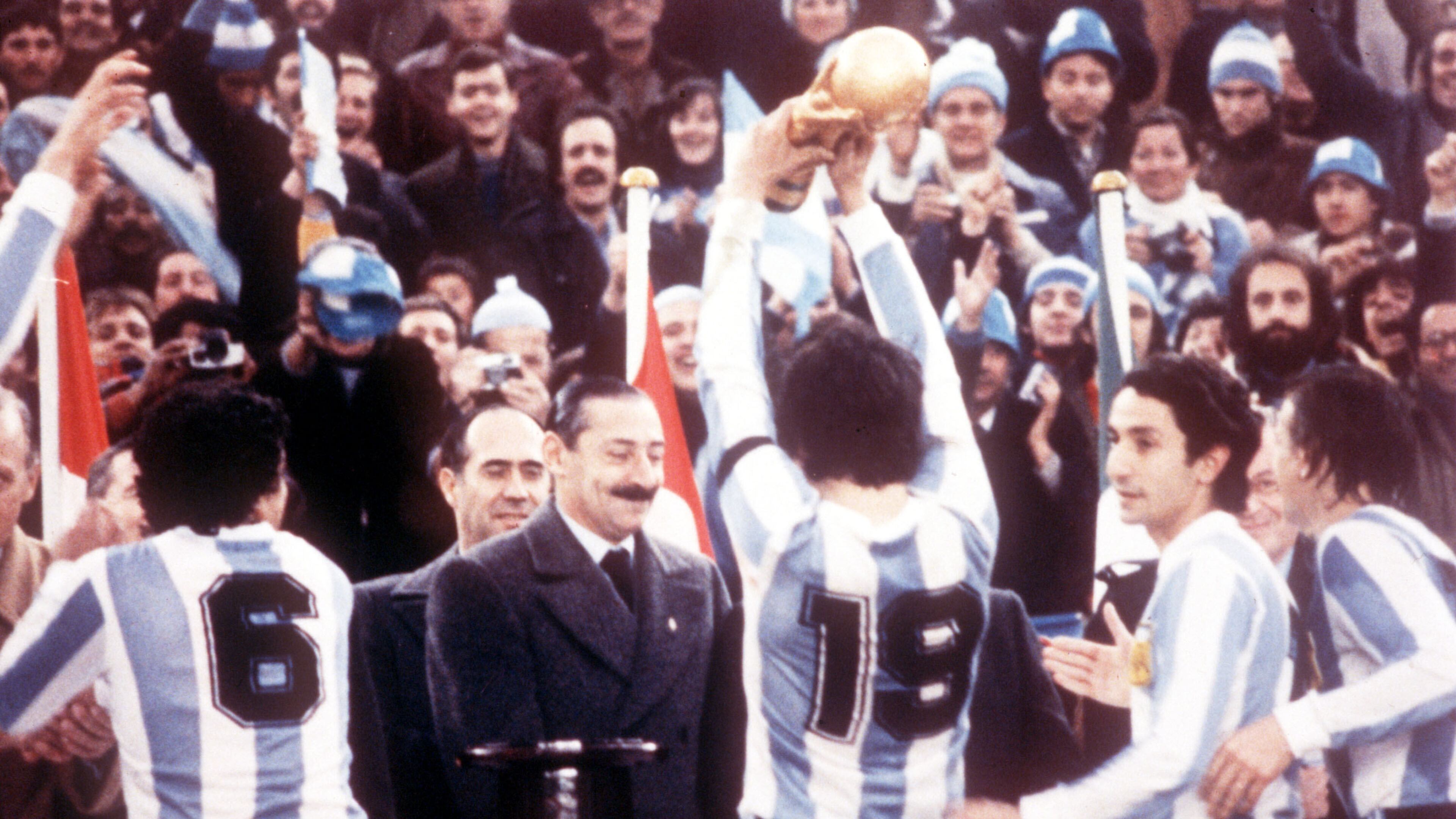 FILE - Argentine President Jorge Rafael Videla, center, looks on after he presented the World Cup Trophy to Argentina's captain Daniel Passarella (19), at the presentation ceremony following the World Cup final soccer match against the Netherlands in the River Plate Stadium in Buenos Aires, June 25, 1978. (AP Photo/Heinz Ducklau)