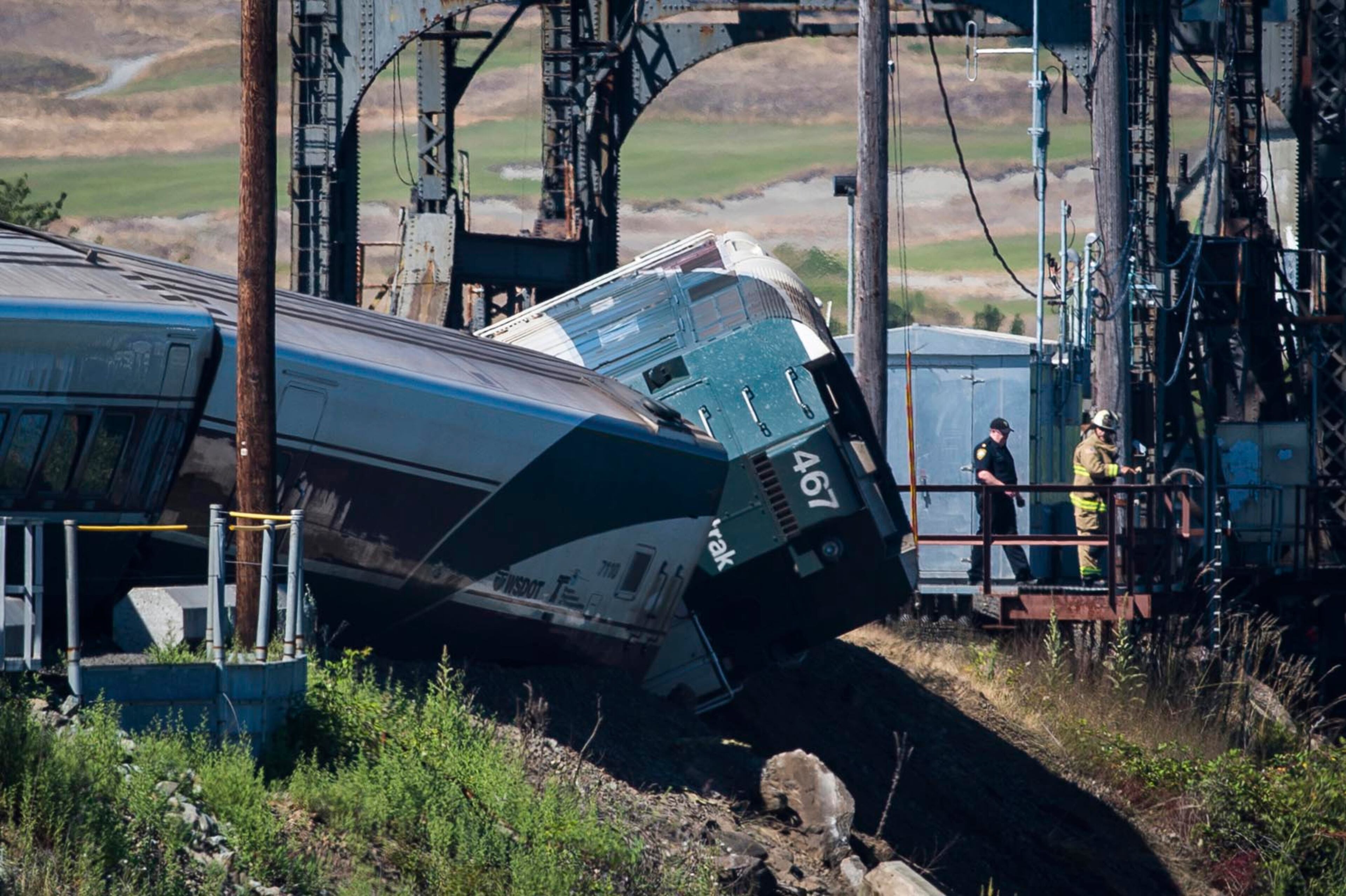 FILE - In this July 2, 2017 file photo, emergency crews respond to the scene of a train derailment near Chambers Bay in Tacoma, Wash. Some of the passengers suffered minor injuries. An Amtrak spokesman said Thursday, July 6, 2017, human error caused the accident. (Joshua Bessex/The News Tribune via AP, File)