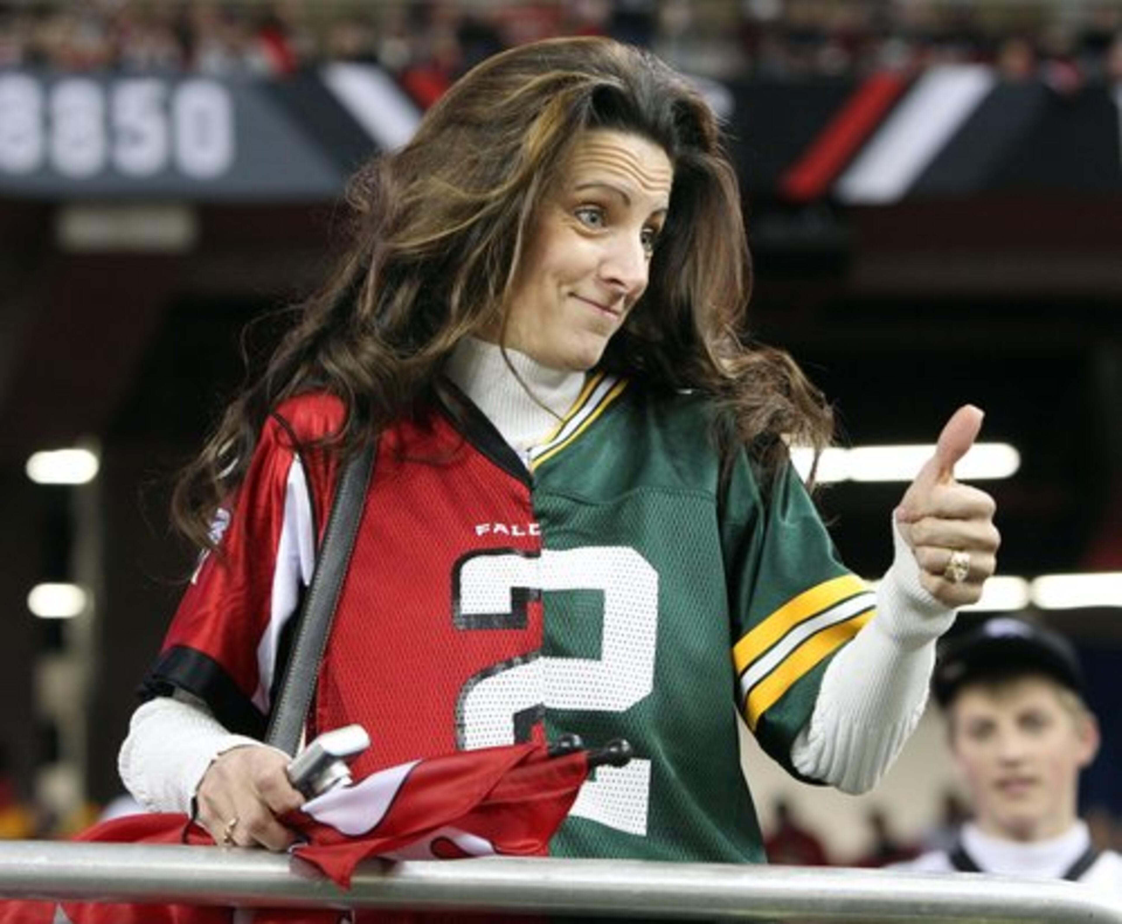 Julieann Craig of Kennesaw has mixed allegiances wearing half a jersey for Falcons quarterback Matt Ryan and half a jersey for Green Bay quarterback Aaron Rodgers at the Georgia Dome before kickoff of the teams' NFC divisional playoff game. Although Craig now lives in Kennesaw, she grew up a cheese head in Wisconsin.