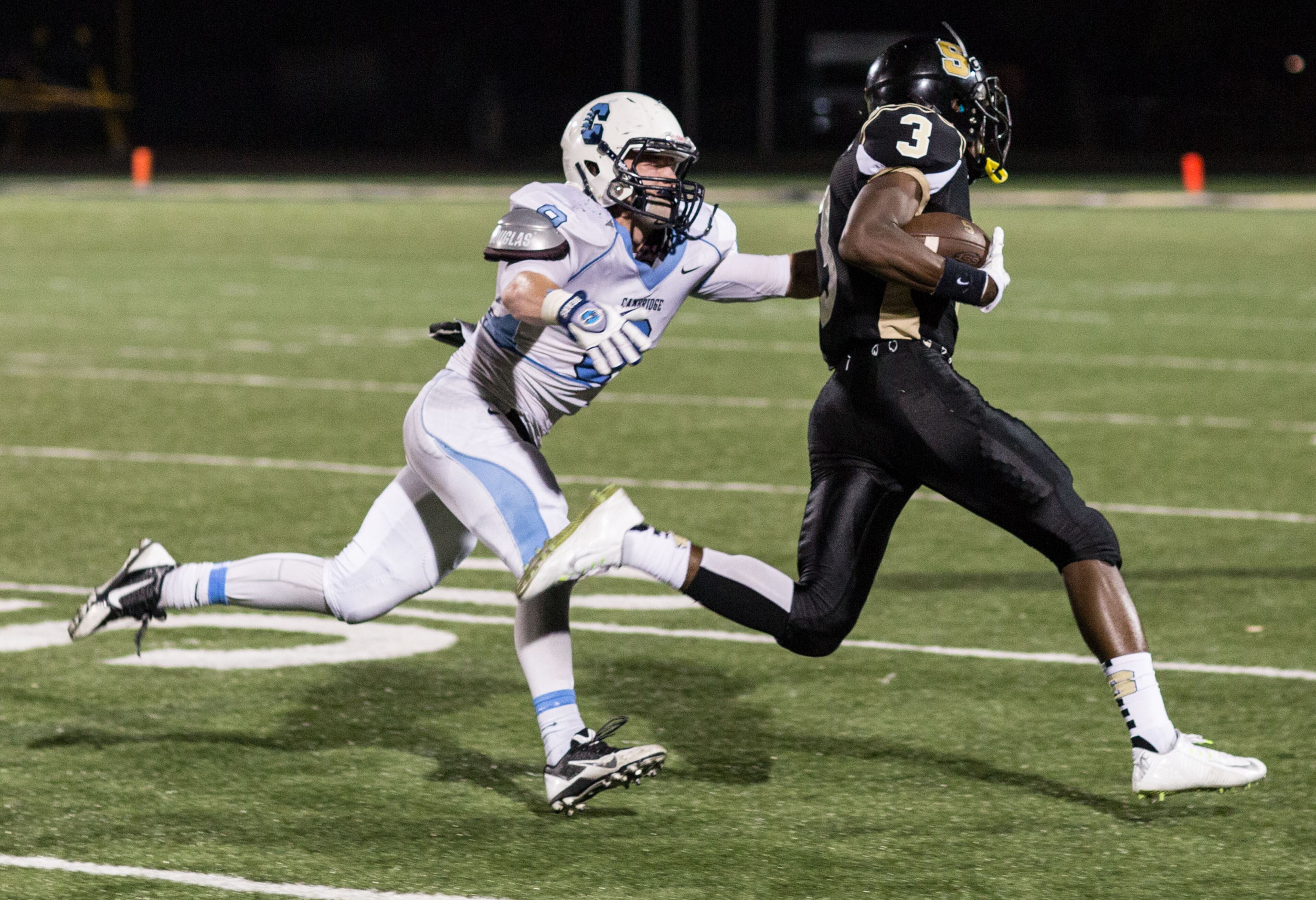 Sprayberry High School wide receiver Jontae Williams (3) runs past Cambridge High School's Charles Mills (8) in Marietta, Ga. Sprayberry defeated Cambridge 31-7. (SPECIAL/BRANDEN CAMP)
