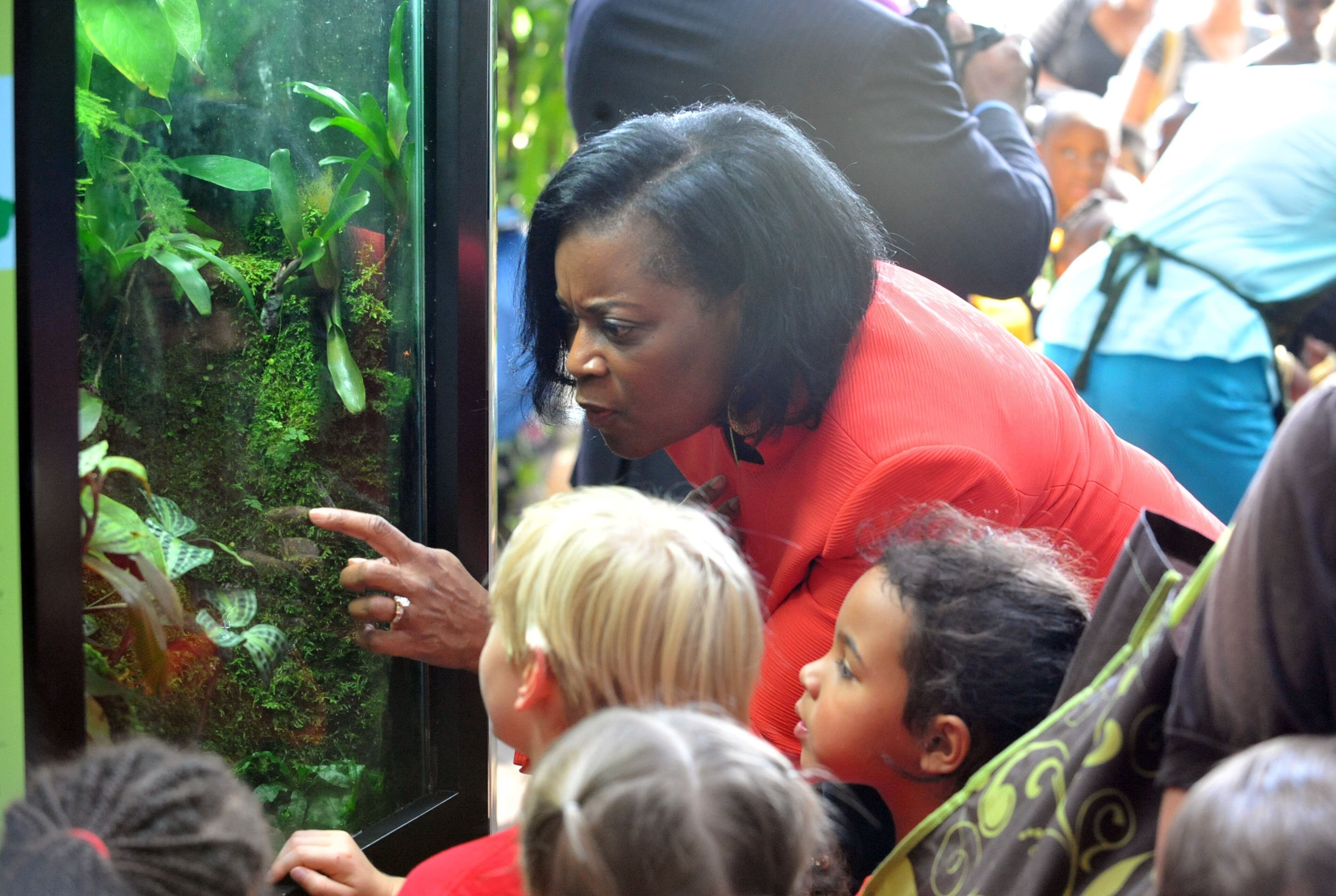 Dr. Linda Anderson, Atlanta Public Schools assistant superintendent of teaching and learning, shows frogs to students from Morris Brandon Elementary.