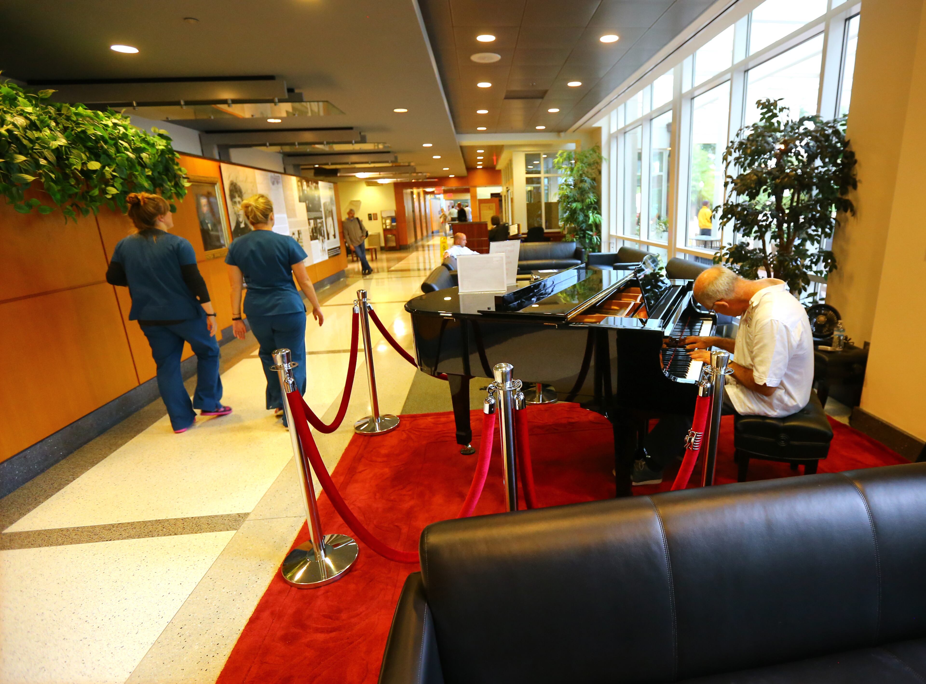 Atlanta singer/songwriter Bruce Gilbert, who struggles to continue to perform as his Parkinson's worsens, plays in the lobby of the Winship Cancer Institute in Atlanta on Tuesday, Oct. 14, 2014. Winship helped save Gilbert's wife from cancer, so he plays the piano in the lobby as a thank you to the center. CURTIS COMPTON / CCOMPTON@AJC.COM