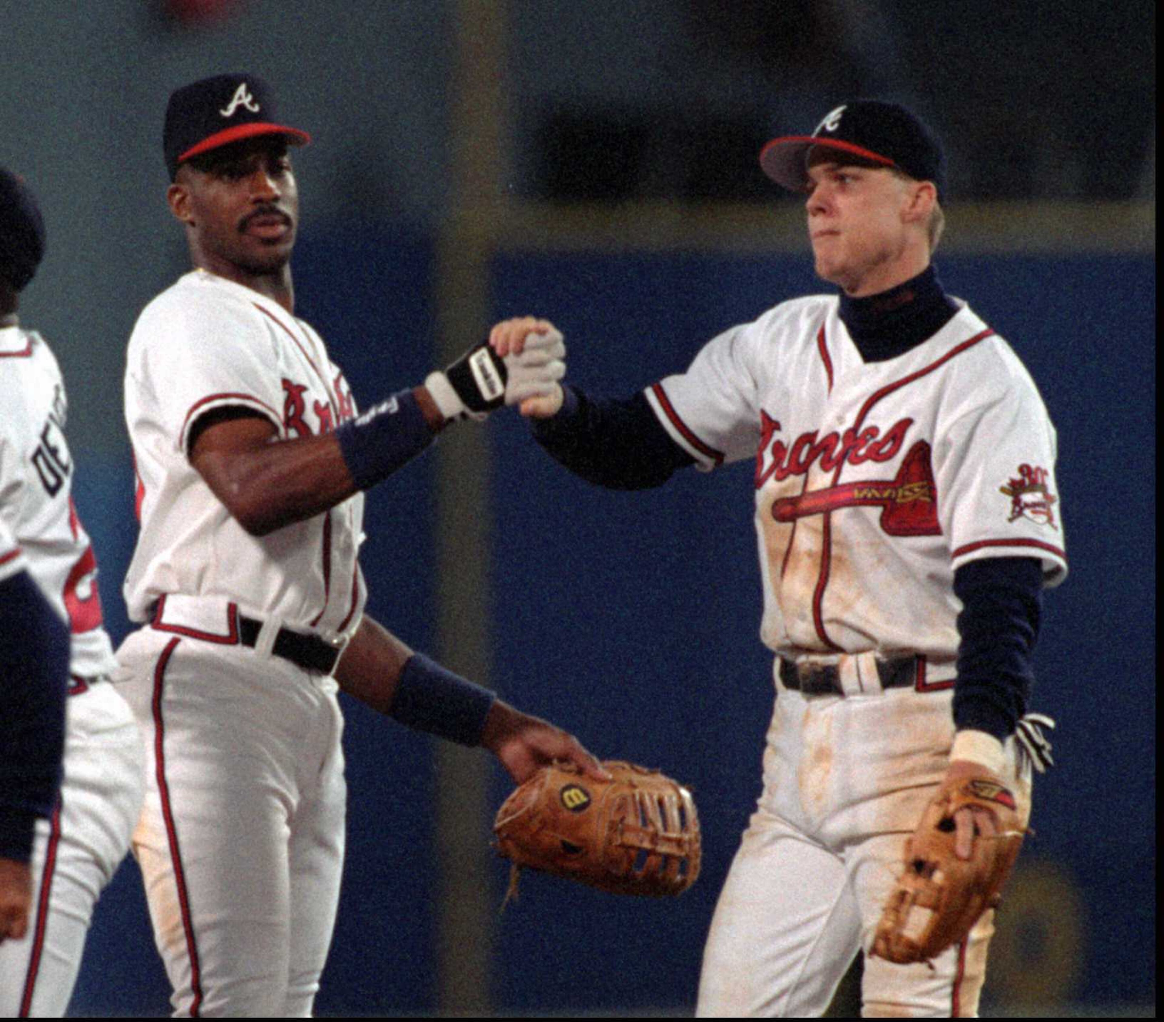 Braves teammates Fred McGriff (left) and Chipper Jones celebrate a win.