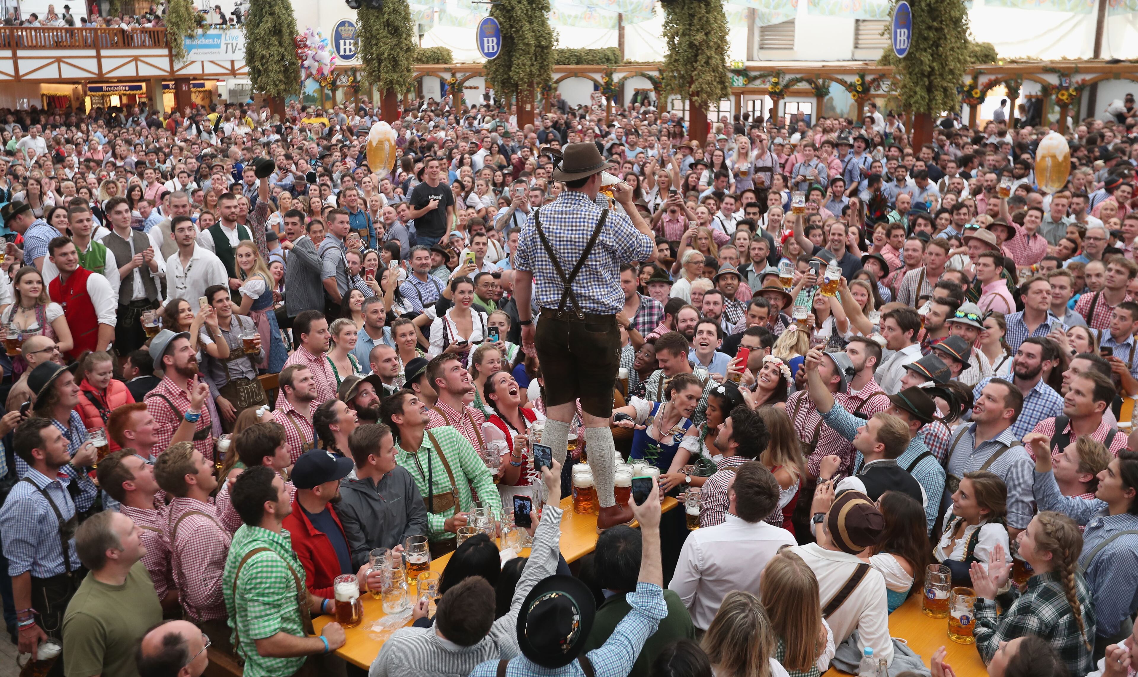 MUNICH, GERMANY - SEPTEMBER 22: Visitors celebrate in a beer tent on the opening day of the 2018 Oktoberfest beer festival on September 22, 2018 in Munich, Germany. The Oktoberfest lasts until October 7 and is the world's largest beer festival. The beer festival typically draws over six million visitors. (Photo by Alexandra Beier/Getty Images)
