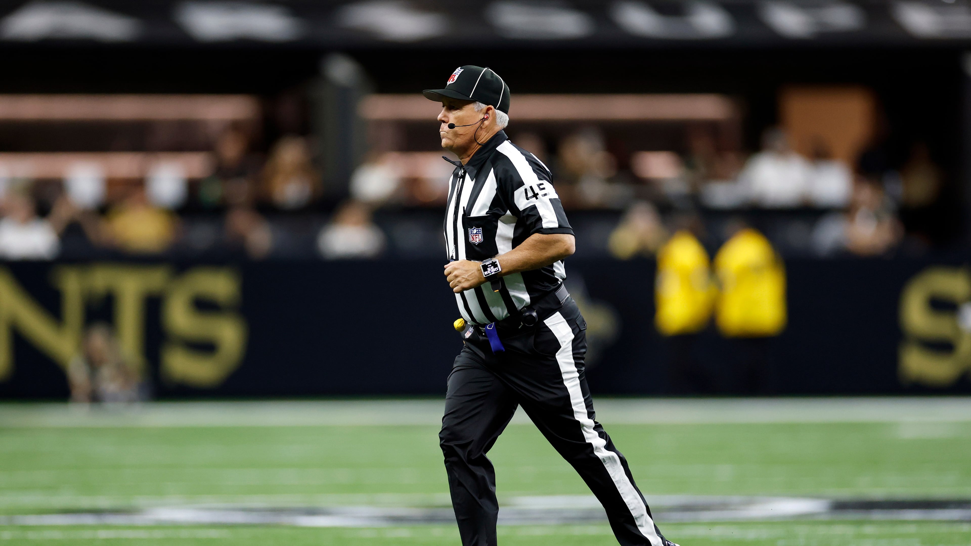 FILE - Line judge Jeff Seeman (45) works during an NFL preseason football game between the New Orleans Saints and the Jacksonville Jaguars in New Orleans, Aug. 15, 2026. (AP Photo/Tyler Kaufman, File)