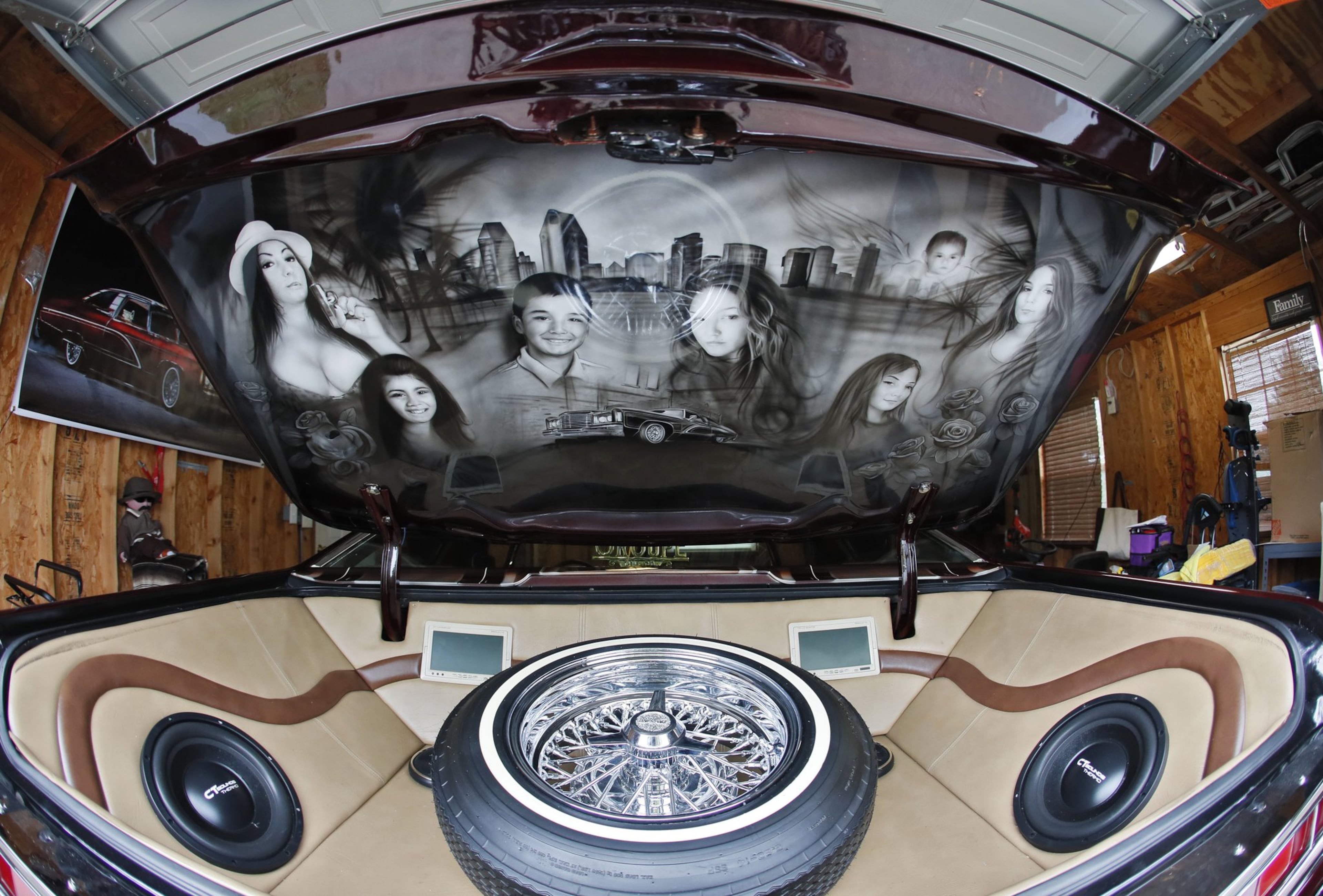 Inside the trunk is a mural of Alfredo “Freddy” Quintero’s family. Bob Andres/robert.andres@ajc.com