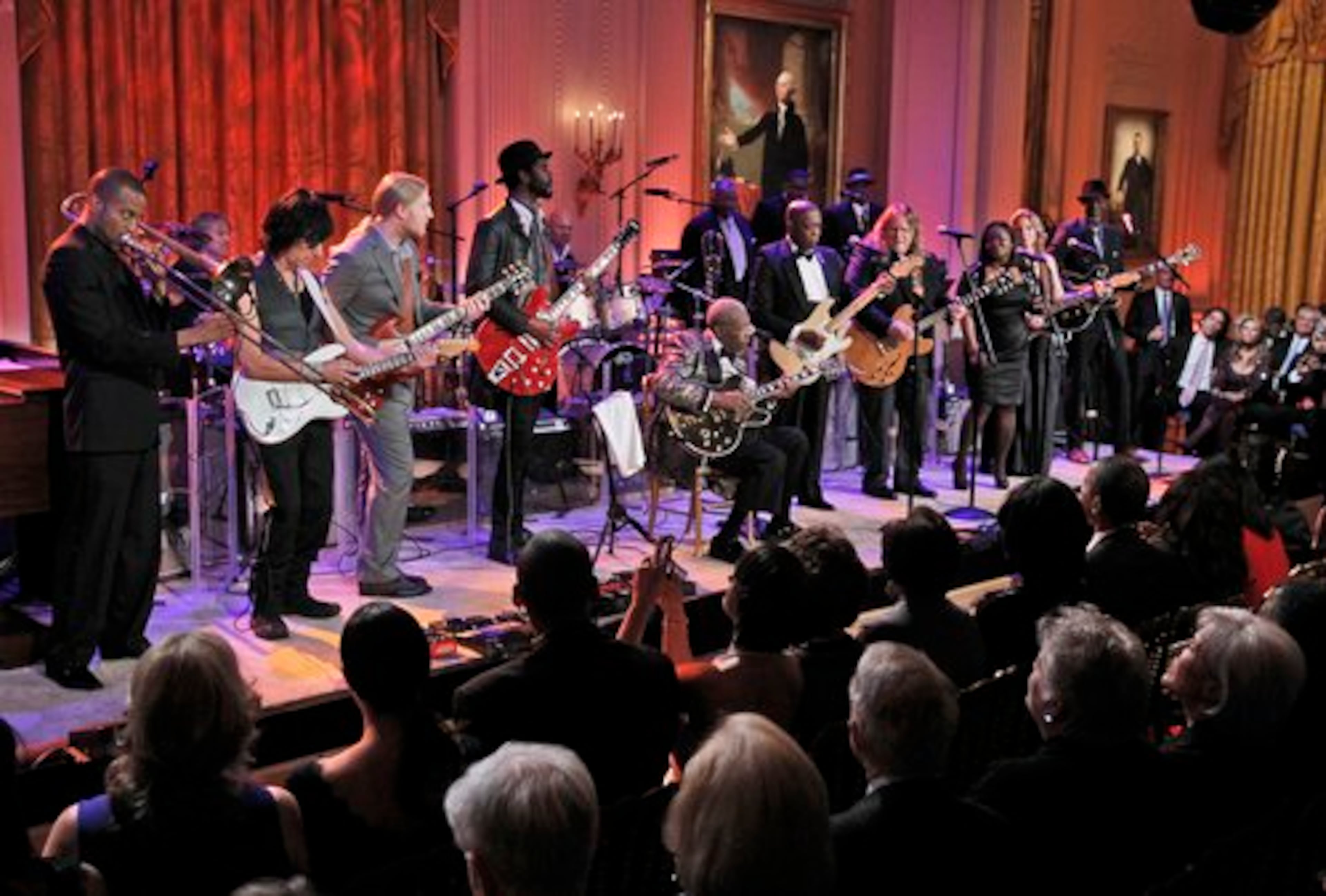 President Barack Obama, first lady Michelle Obama and their guests listen to Troy "Trombone Shorty" Andrews, Jeff Beck, Derek Trucks, Gary Clark Jr., B.B. King, Buddy Guy, Warren Haynes, Shemekia Copeland, Susan Tedeschi and Keb Mo. At the end of the evening, President Obama was persuaded to join in on singing "Sweet Home Chicago," the blues anthem of his hometown.