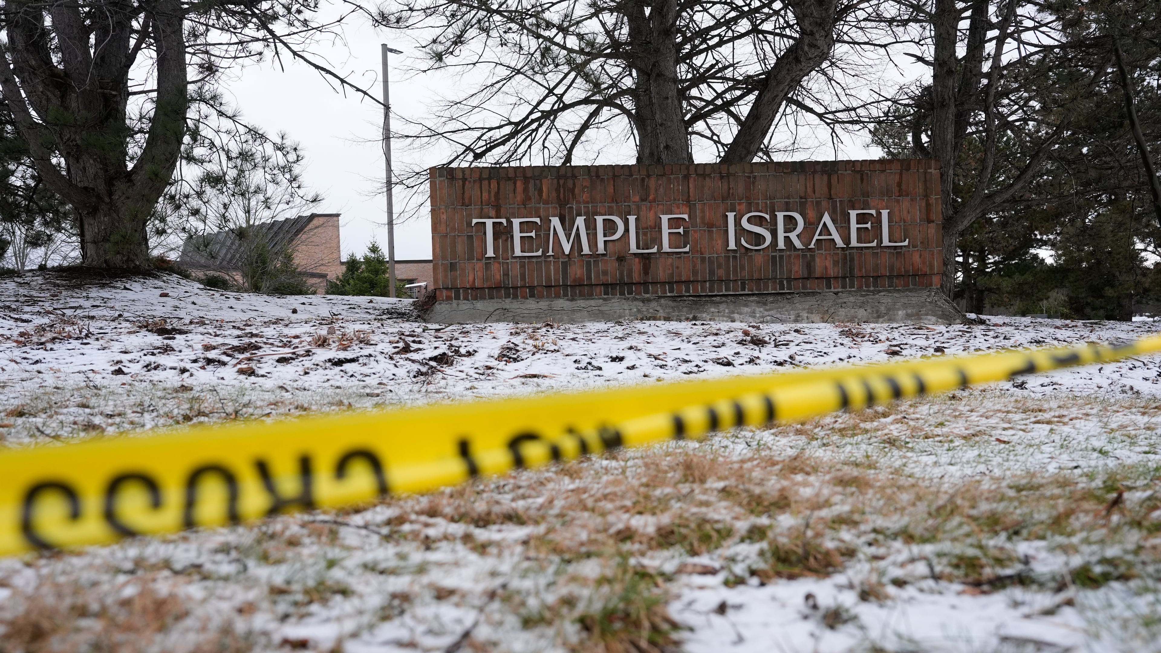 FILE - Police tape hangs outside the Temple Israel synagogue on March 13, 2026, in West Bloomfield Township, Mich. (AP Photo/Paul Sancya, File)