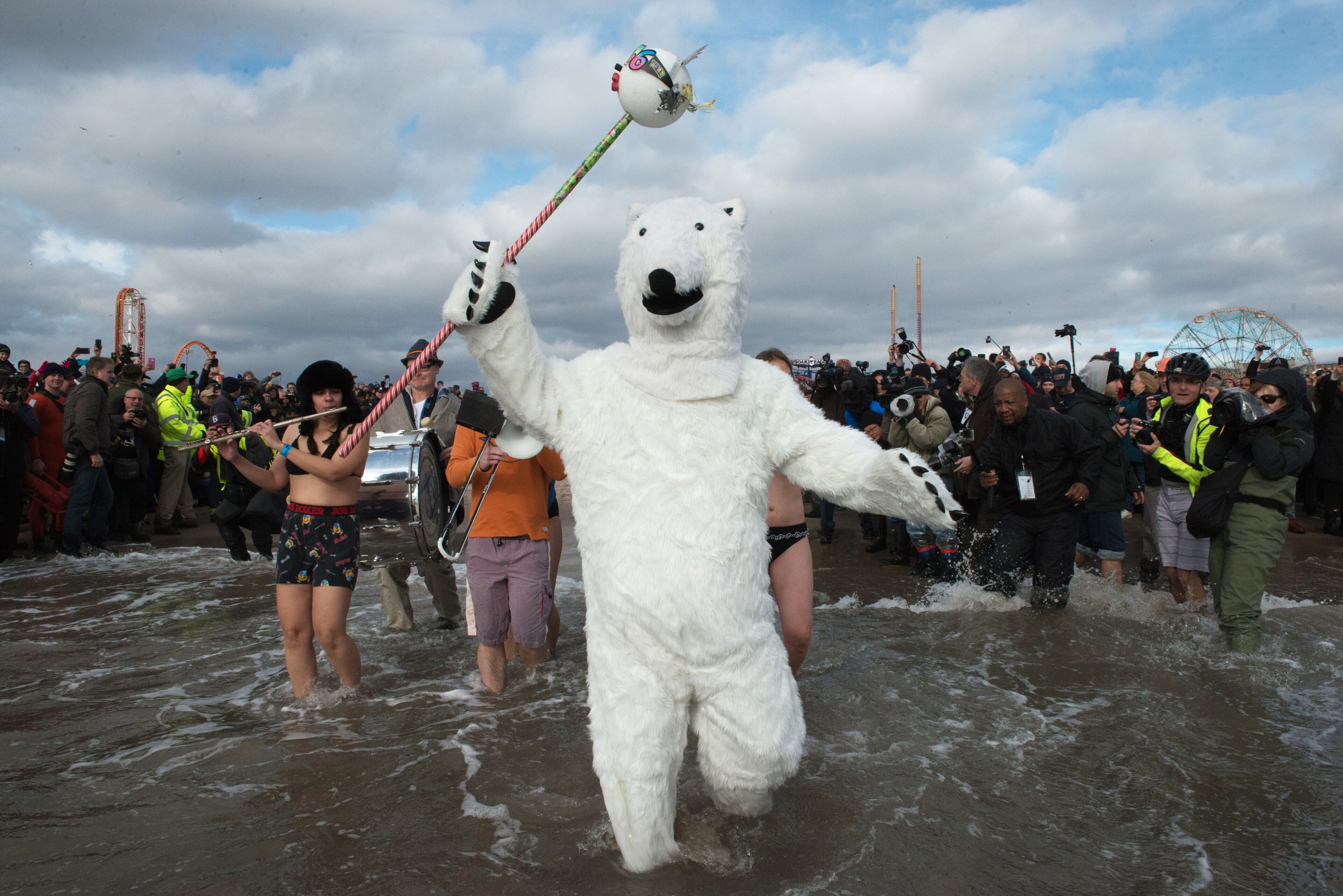 NEW YORK, NY - JANUARY 01: A man dressed as a polar bear walks into the ocean during the annual Coney Island Polar Bear Club New Year's Day swim on January 1, 2016 in the Brooklyn borough of New York City. The Coney Island Polar Bear Club claims to be the oldest winter bathing organization in the U.S. and attracts hundreds to the beach for the annual swim in the Atlantic Ocean. (Photo by Stephanie Keith/Getty Images) *** BESTPIX ***