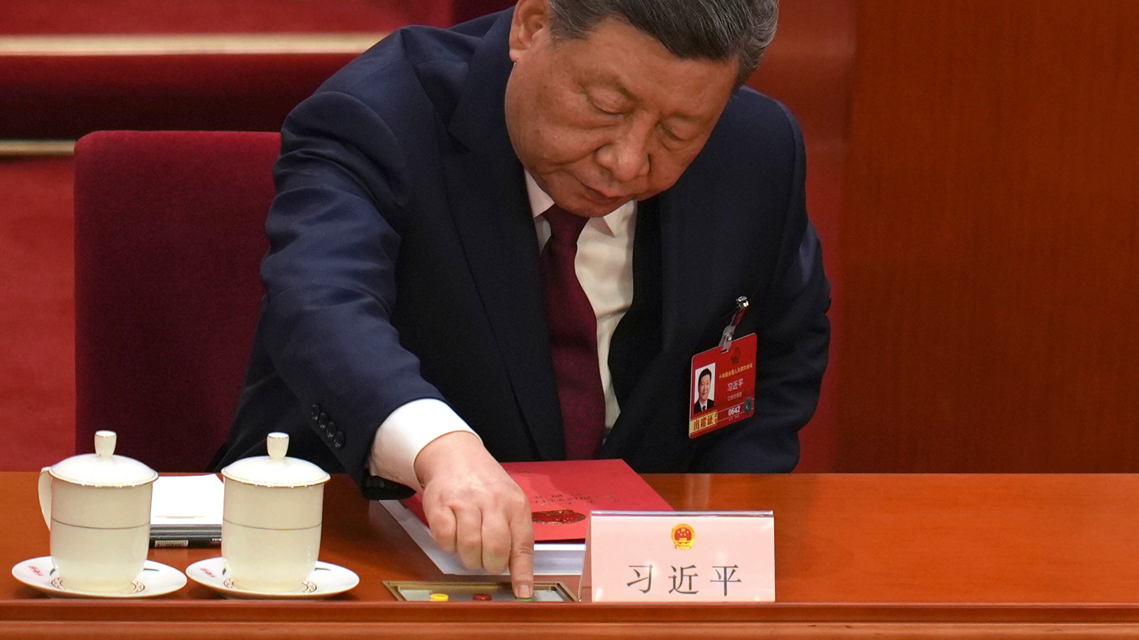 Chinese President Xi Jinping, presses a button to cast his vote during the closing session of the National People's Congress (NPC) at the Great Hall of the People in Beijing, Thursday, March 12, 2026. (AP Photo/Ng Han Guan)