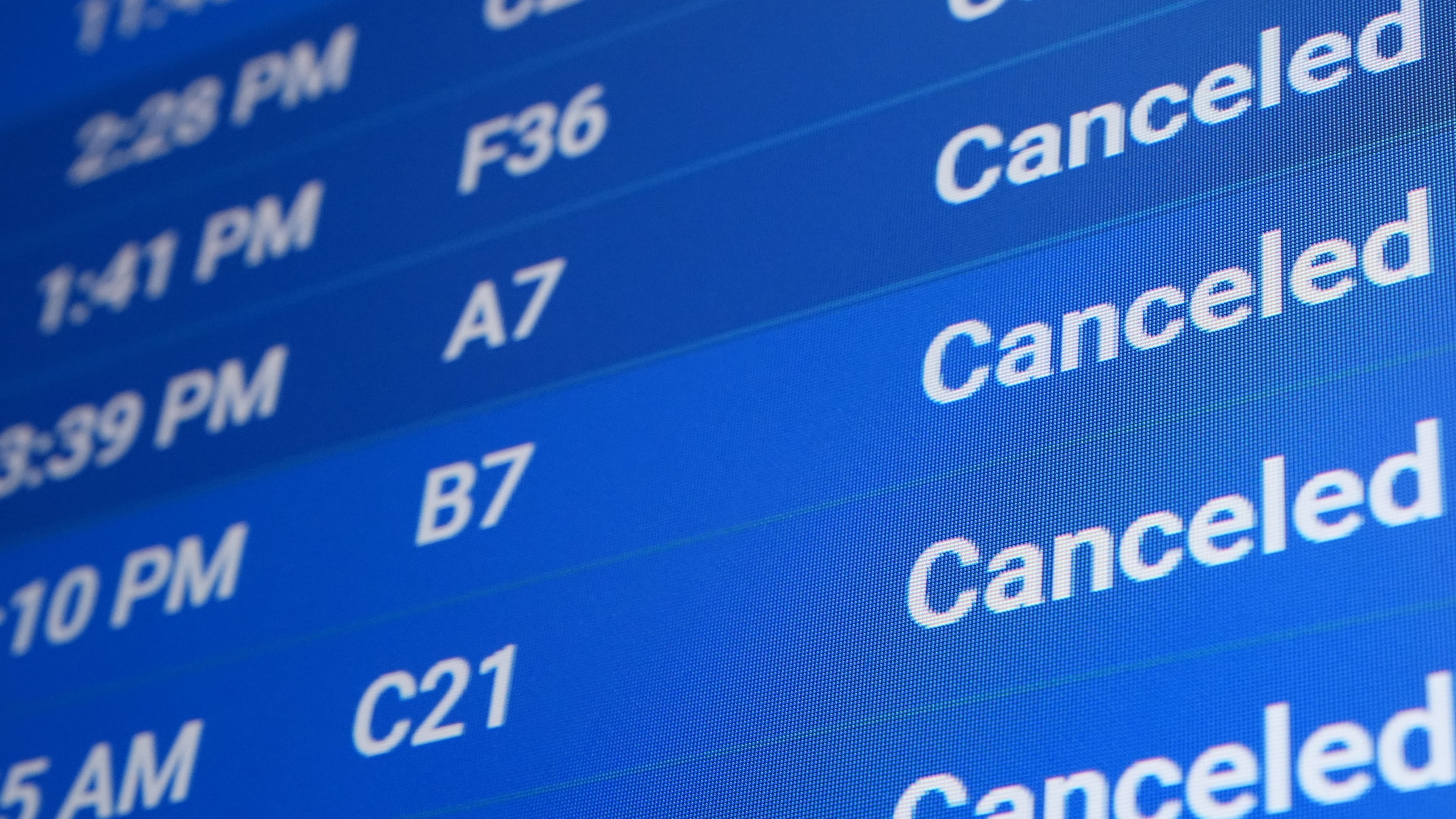 A flight status screen shows canceled flights at Philadelphia International Airport during a winter storm in Philadelphia, Sunday, Jan. 25, 2026. (AP Photo/Matt Rourke)