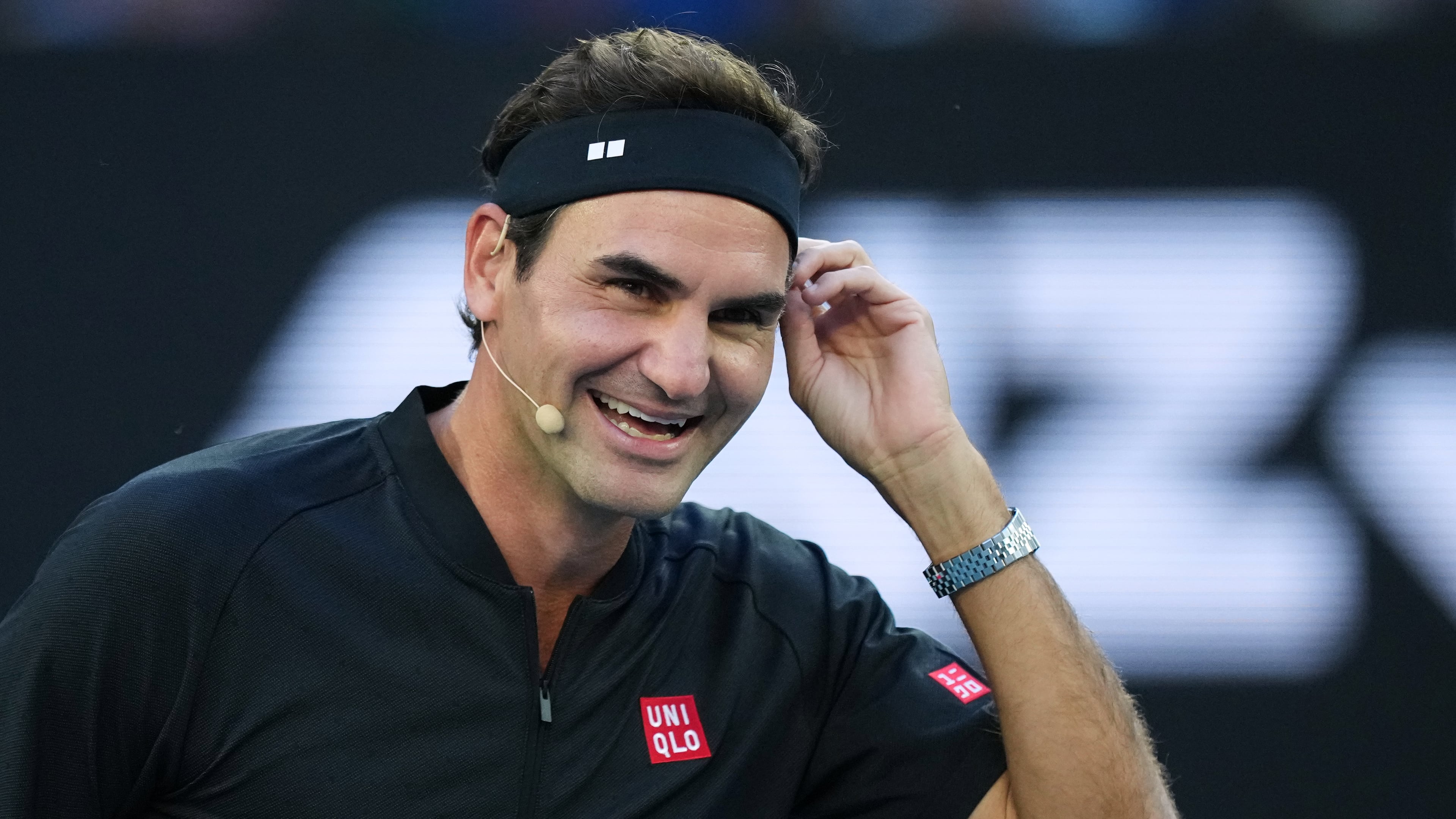 FILE - Roger Federer of Switzerland reacts with partner Andre Agassi of the United States in their doubles match against Lleyton Hewitt and Pat Rafter of Australia during the Opening Ceremony for the Australian Open tennis championship in Melbourne, Australia, Jan. 17, 2026. (AP Photo/Aaron Favila, File)
