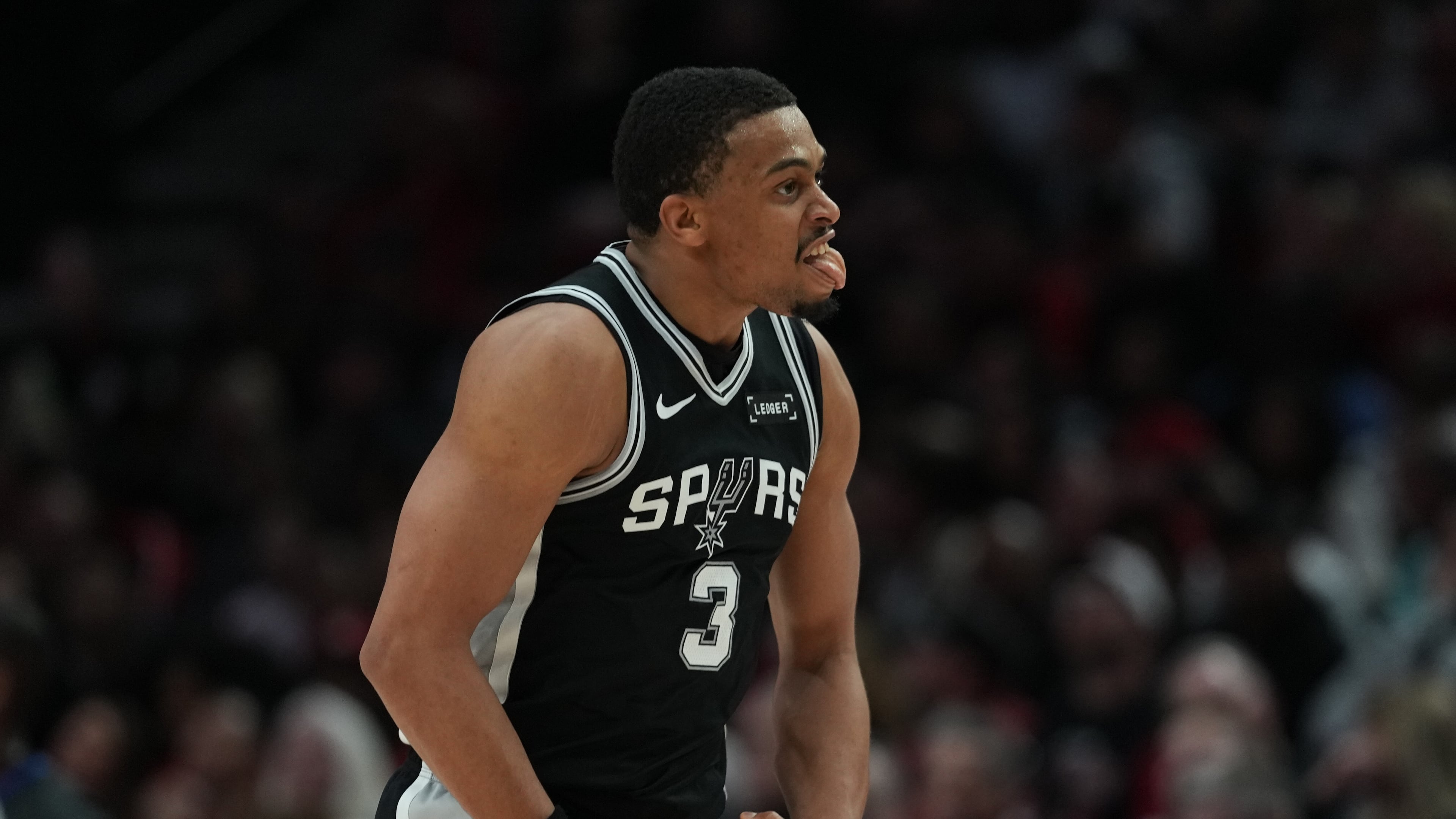 San Antonio Spurs forward Keldon Johnson (3) reacts after scoring against the Portland Trail Blazers during the second half in Game 3 of a first-round NBA playoffs basketball series in Portland, Ore, Friday, April 24, 2026. (AP Photo/Jenny Kane)