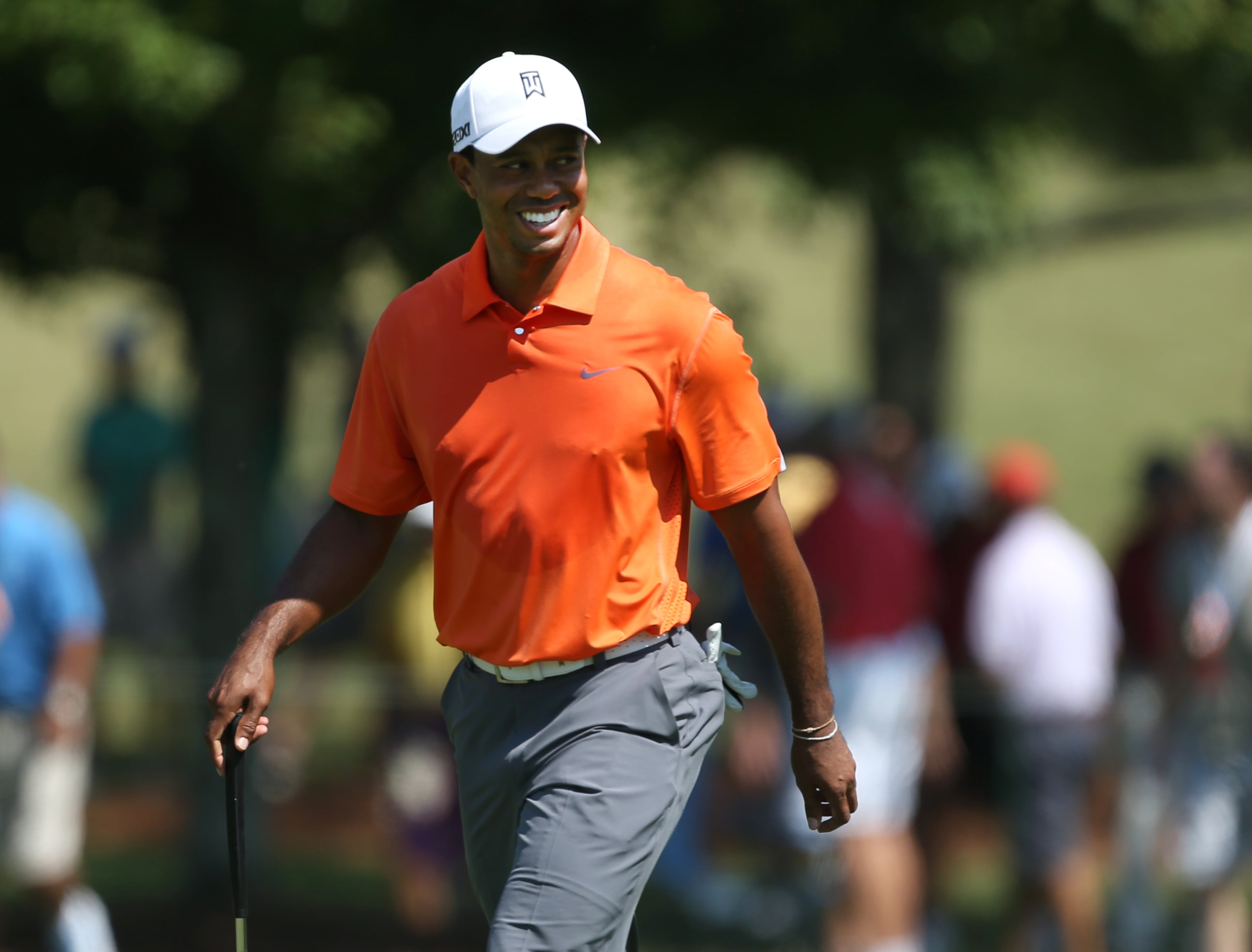 Tiger Woods talks with his caddie as he walks down the No. 1 fairway during round one of the 2013 Tour Championship at East Lake Golf Club Thursday morning in Atlanta, Ga., September 19, 2013. Woods finished in 29th place with a round of 3 over par.