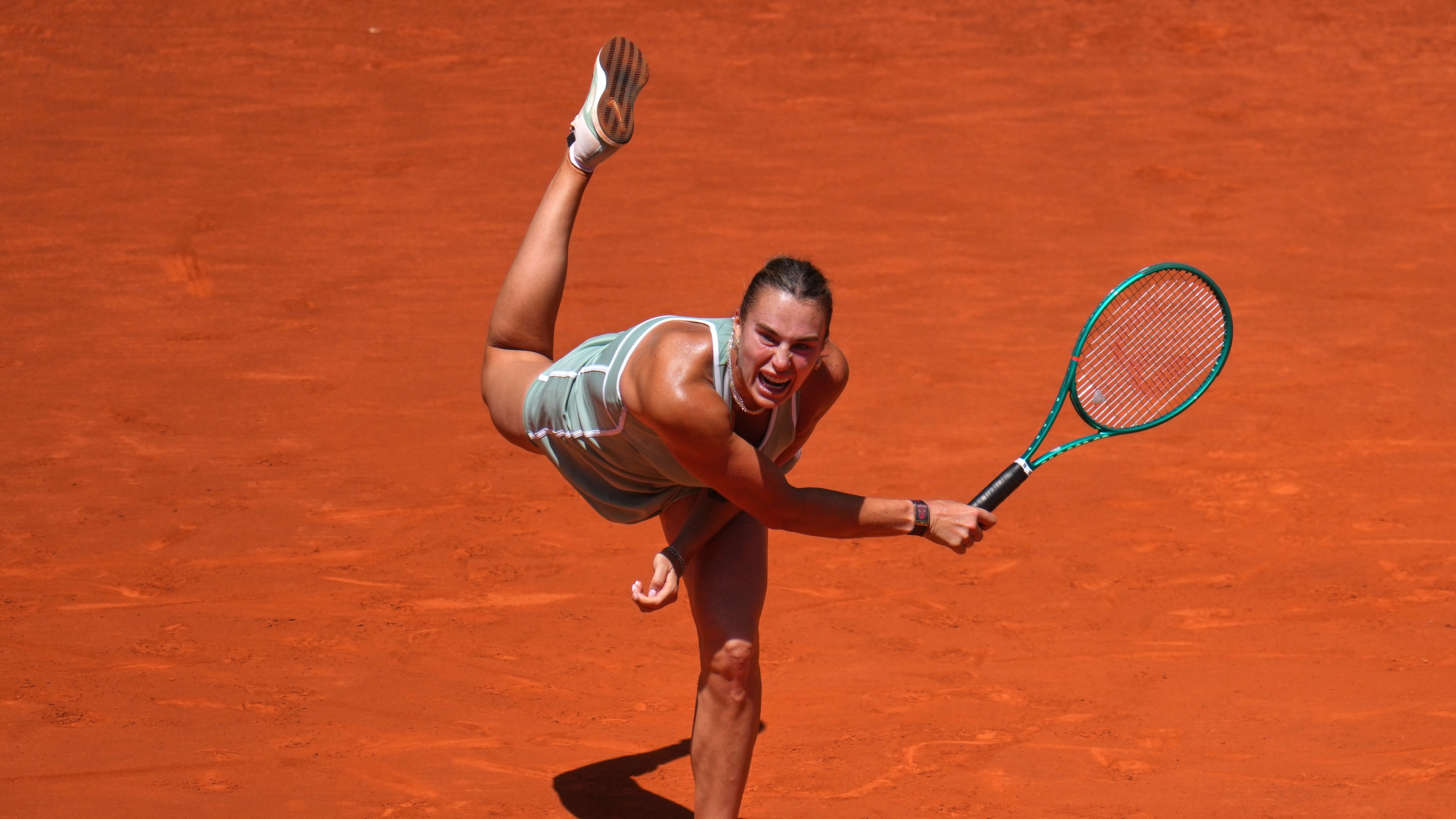 Aryna Sabalenka of Belarus serves the ball to Naomi Osaka of Japan during the Madrid Open tennis tournament in Madrid, Monday, April 27, 2026. (AP Photo/Manu Fernandez)