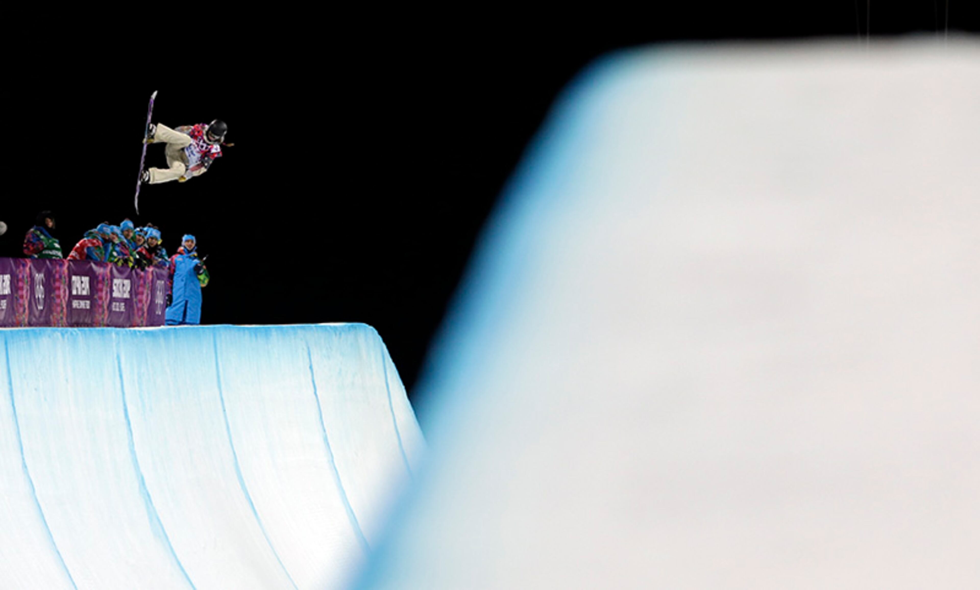 United States' Kaitlyn Farrington competes on her way to win the women's snowboard halfpipe final at the Rosa Khutor Extreme Park, at the 2014 Winter Olympics, Wednesday, Feb. 12, 2014, in Krasnaya Polyana, Russia.
