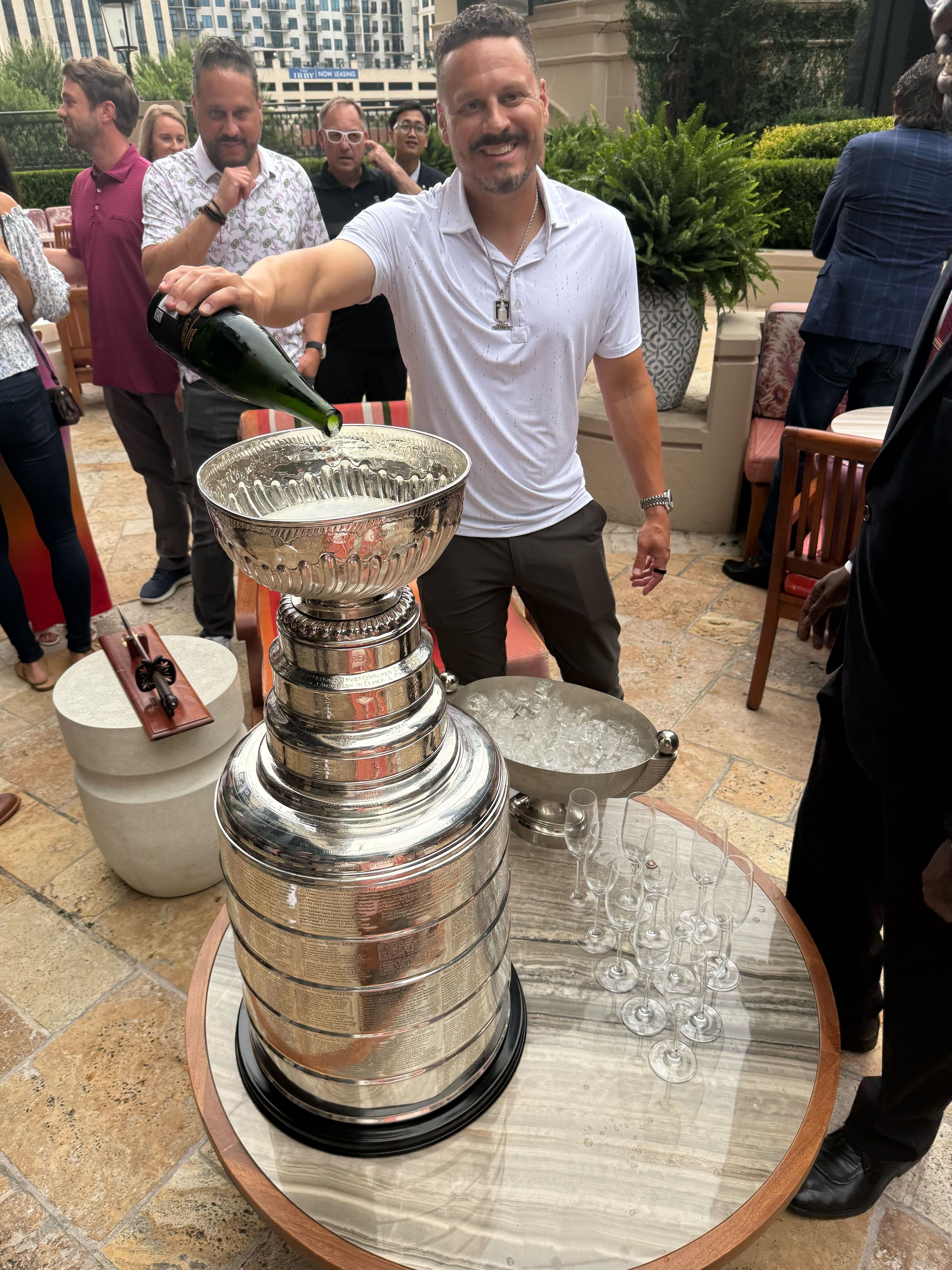 Mike Huff pours champagne into the Stanley Cup at the St. Regis Atlanta. (Courtesy of Brad Pendergrass)
