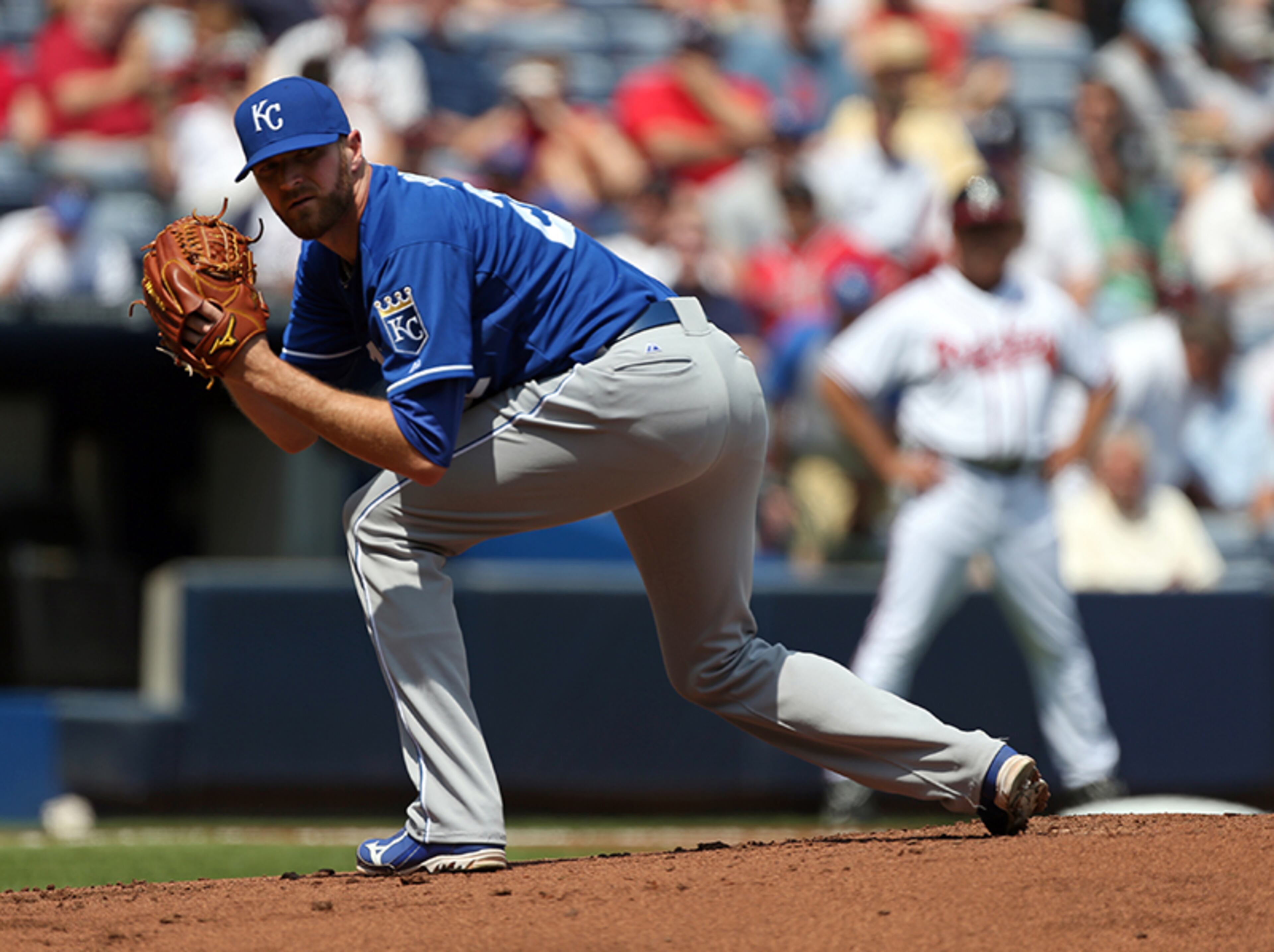Royals starting pitcher Wade Davis looks back to first base in the first inning to hold back a runner.