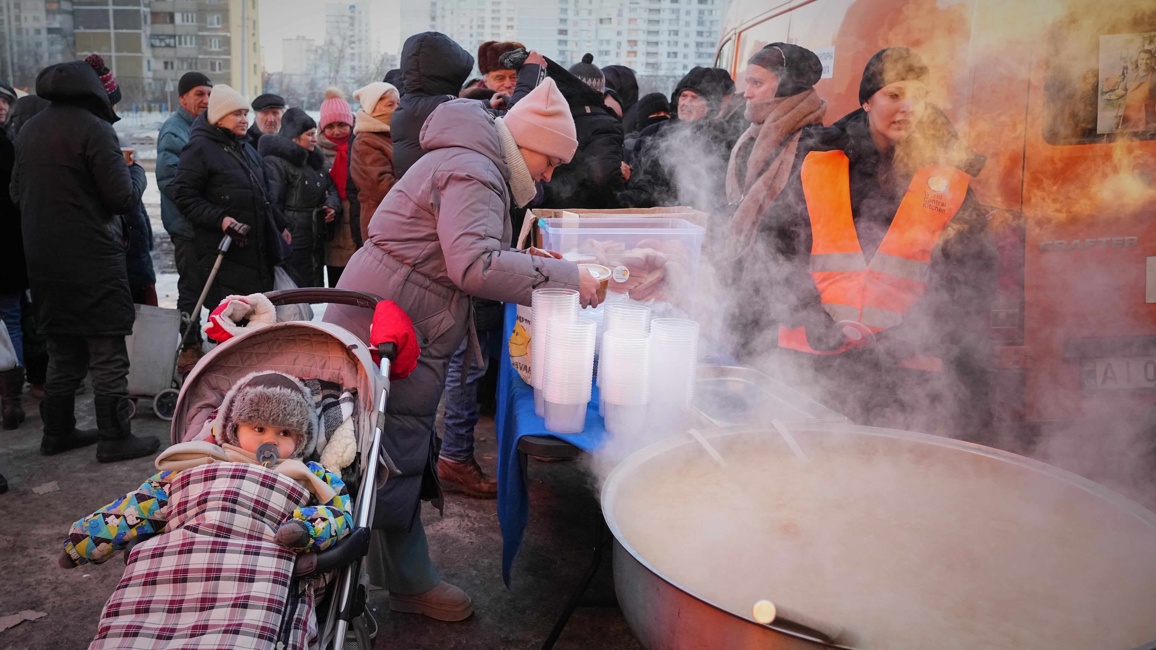 Yuliia Dolotova, 37, receives hot food at a distribution point during a power outage caused by Russia’s repeated air strikes on the country’s power grid, in Kyiv, Ukraine, Monday, Feb. 2, 2026. (AP Photo/Sergey Grits)
