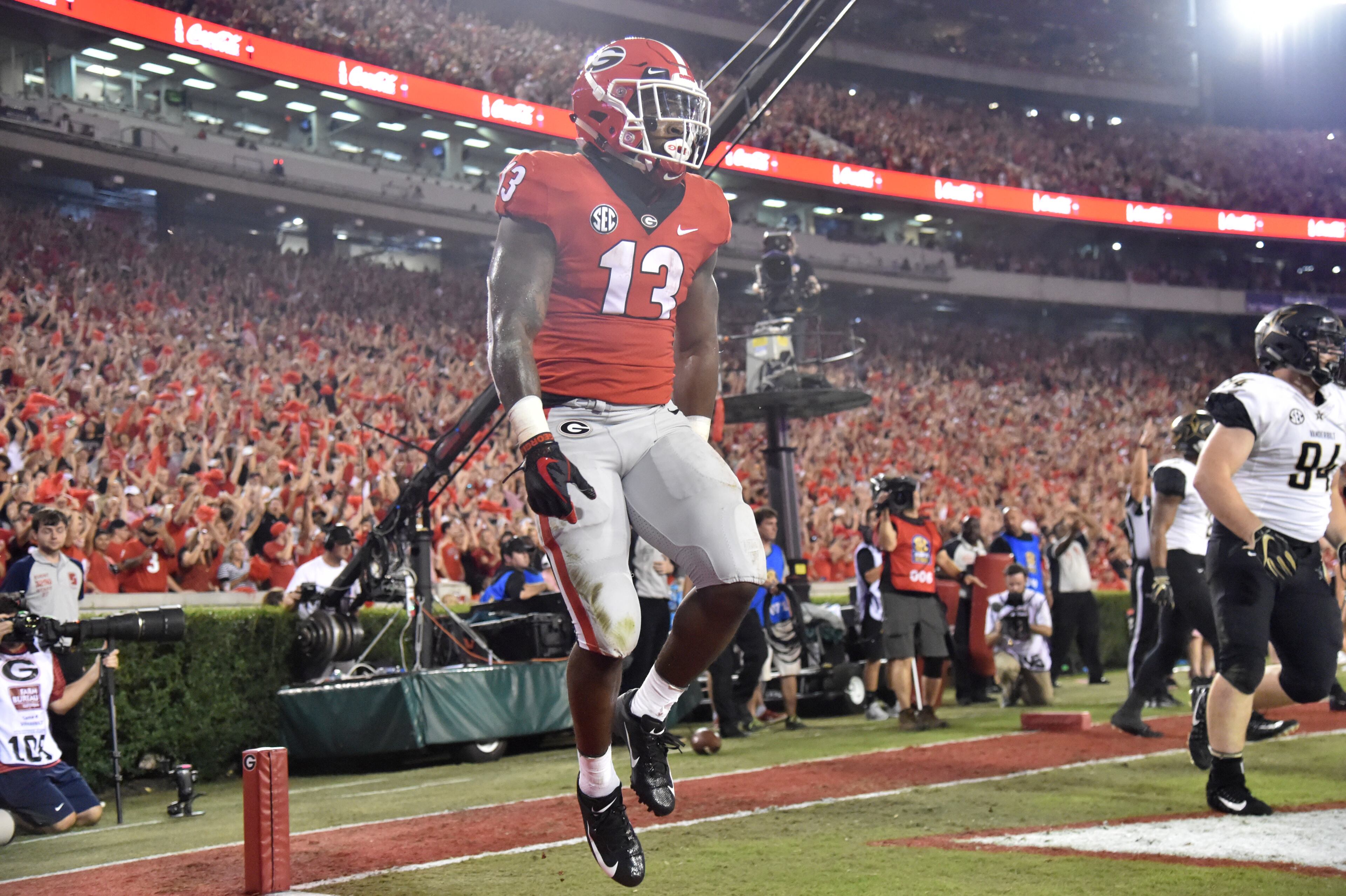 October 6, 2018 Athens - Georgia running back Elijah Holyfield (13) celebrates after he scored a touchdown in the first half during a NCAA college football game at Sanford Stadium in Athens on Saturday, October 6, 2018. HYOSUB SHIN / HSHIN@AJC.COM