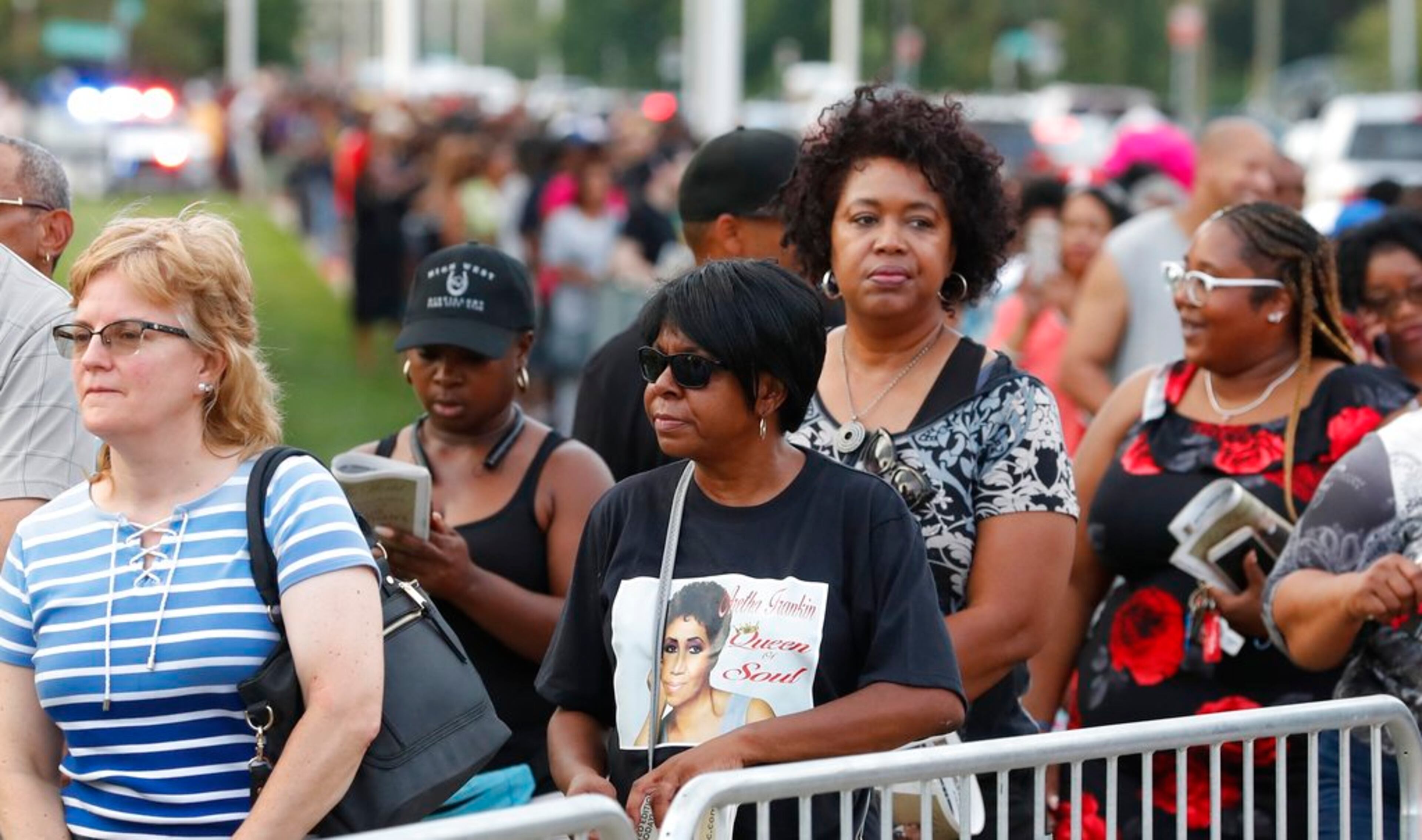 Fans wait in line at the Charles H. Wright Museum of African American History where Aretha Franklin is lying in state, Tuesday, Aug. 28, 2018, in Detroit. (AP Photo/Carlos Osorio)