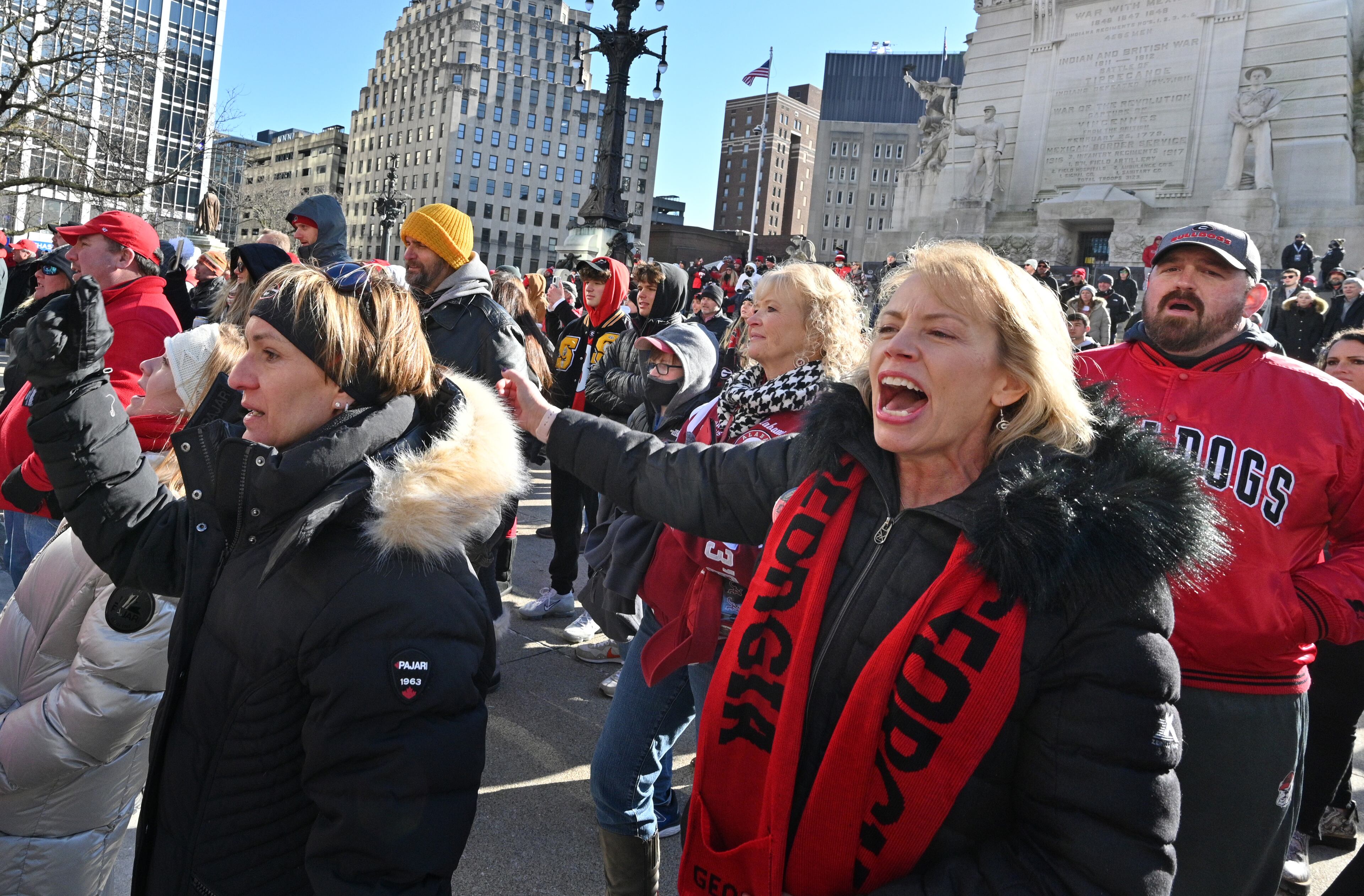 Georgia fans cheer as Georgia Redcoat Marching Band performs during Allstate Championship Tailgate event at Monument Circle prior to the 2022 College Football Playoff National Championship Game at Lucas Oil Stadium in Indianapolis on Monday, January 10, 2022. (Hyosub Shin / Hyosub.Shin@ajc.com)