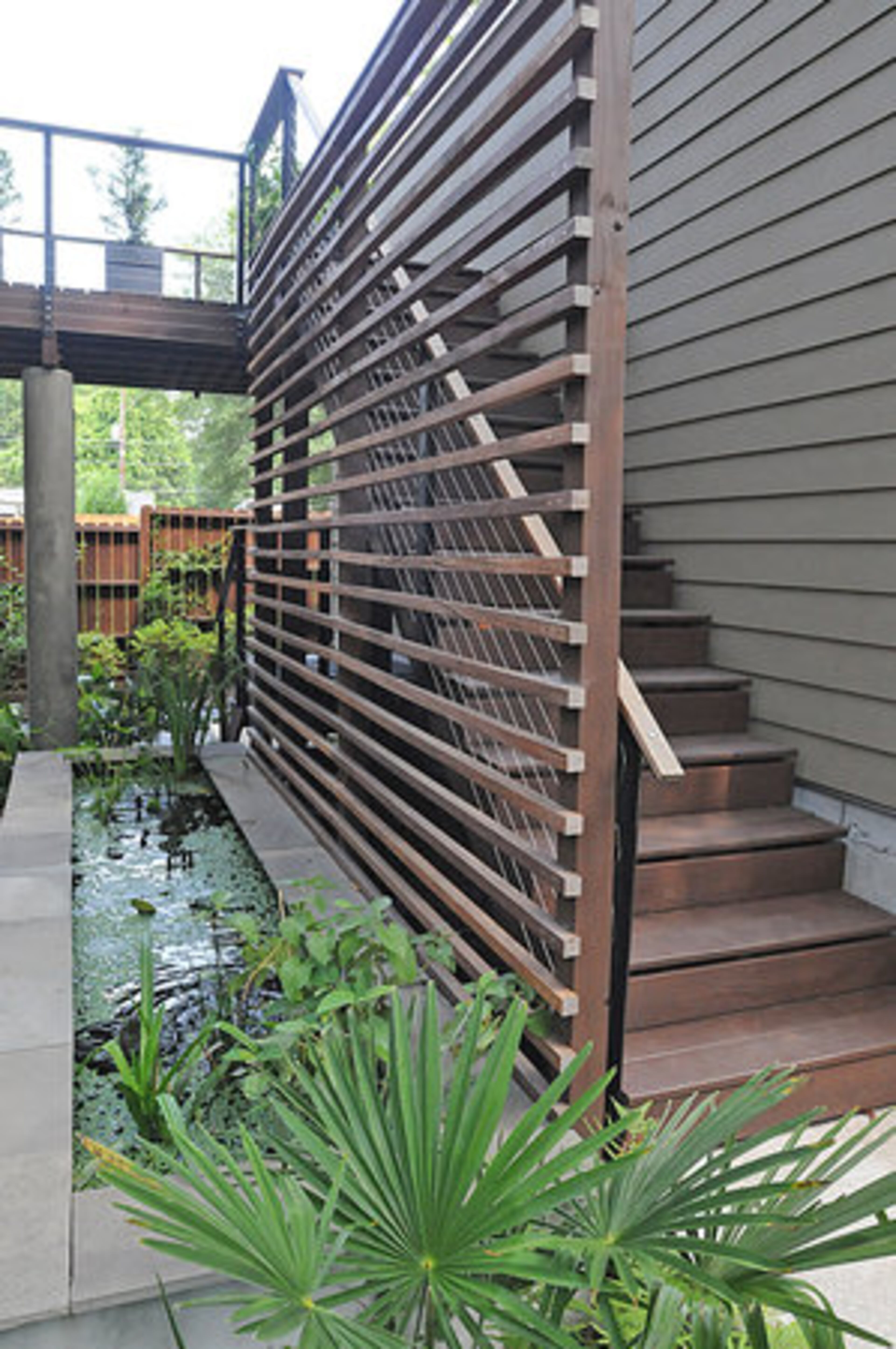 The koi pond is one of the many elements that make the backyard a soothing retreat. The outdoor area can be accessed from dual levels.