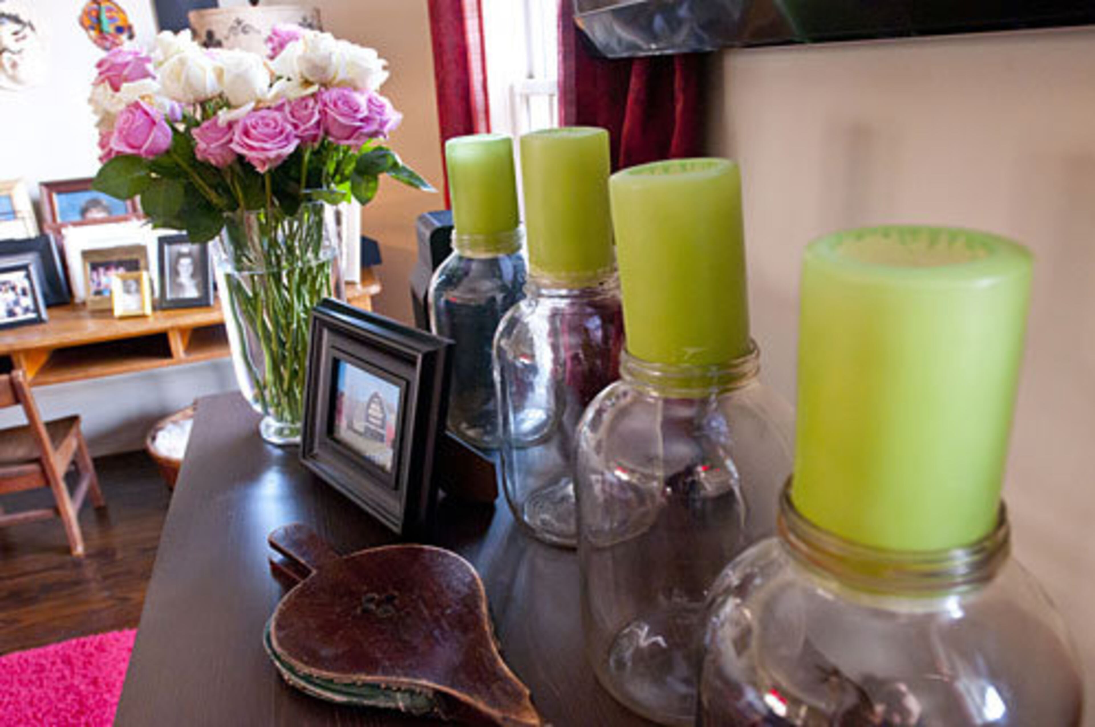 "I put green candles in pickles jars beneath the TV in the living room. I change the candles out seasonally with other candles, or pennies or other unique looking pieces that I might find."