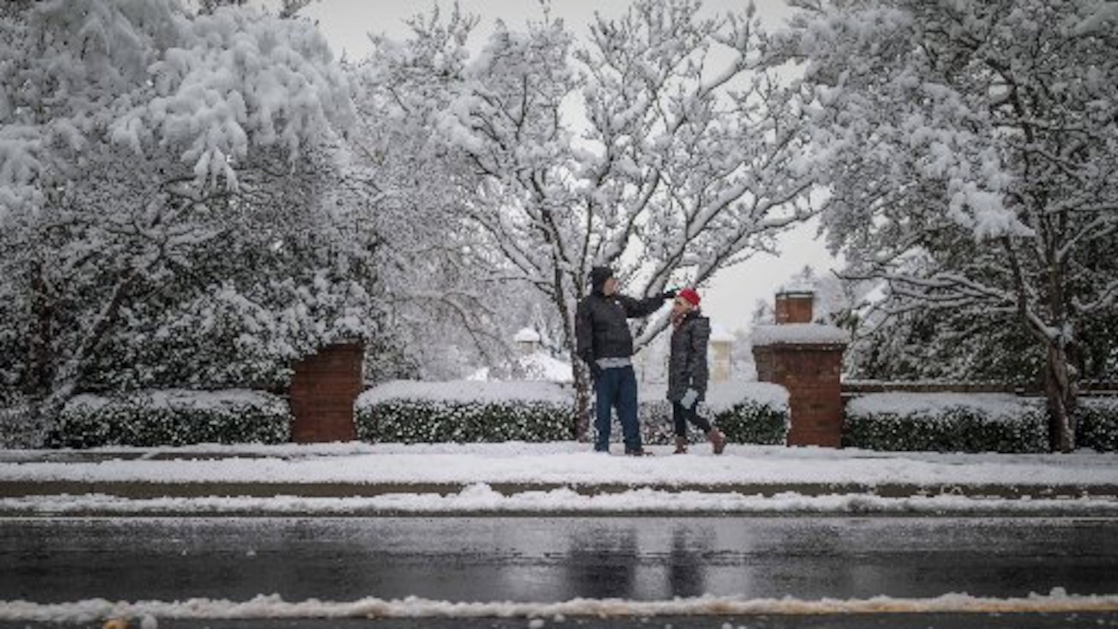 People walk along Shiloh Road in Kennesaw after a snowstorm hit metro Atlanta and North Georgia.