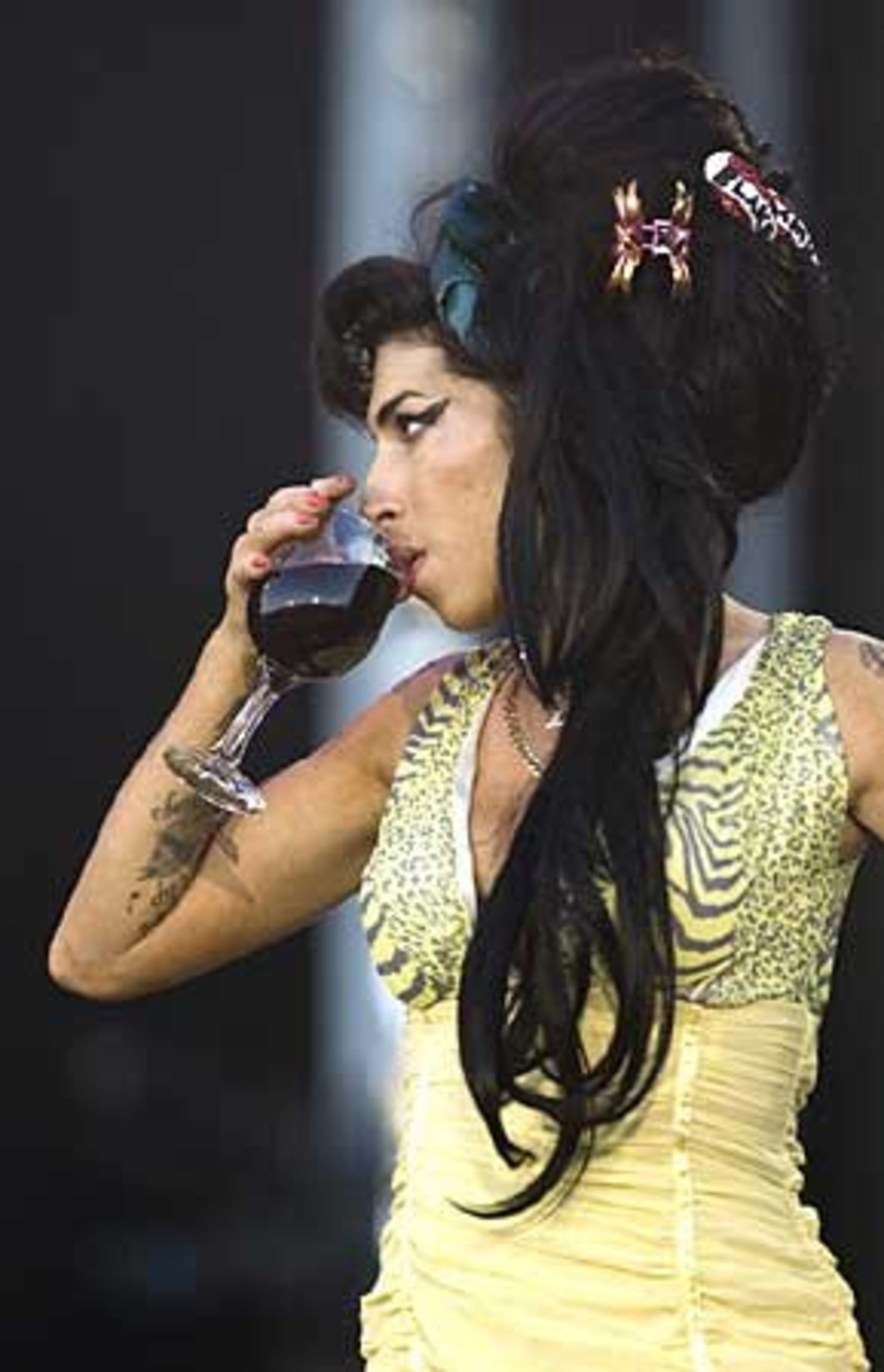 Wine glass in hand, British jazz-soul singer Amy Winehouse performs during the Rock in Rio music festival in Arganda del Rey, on the outskirts of Madrid, Spain.