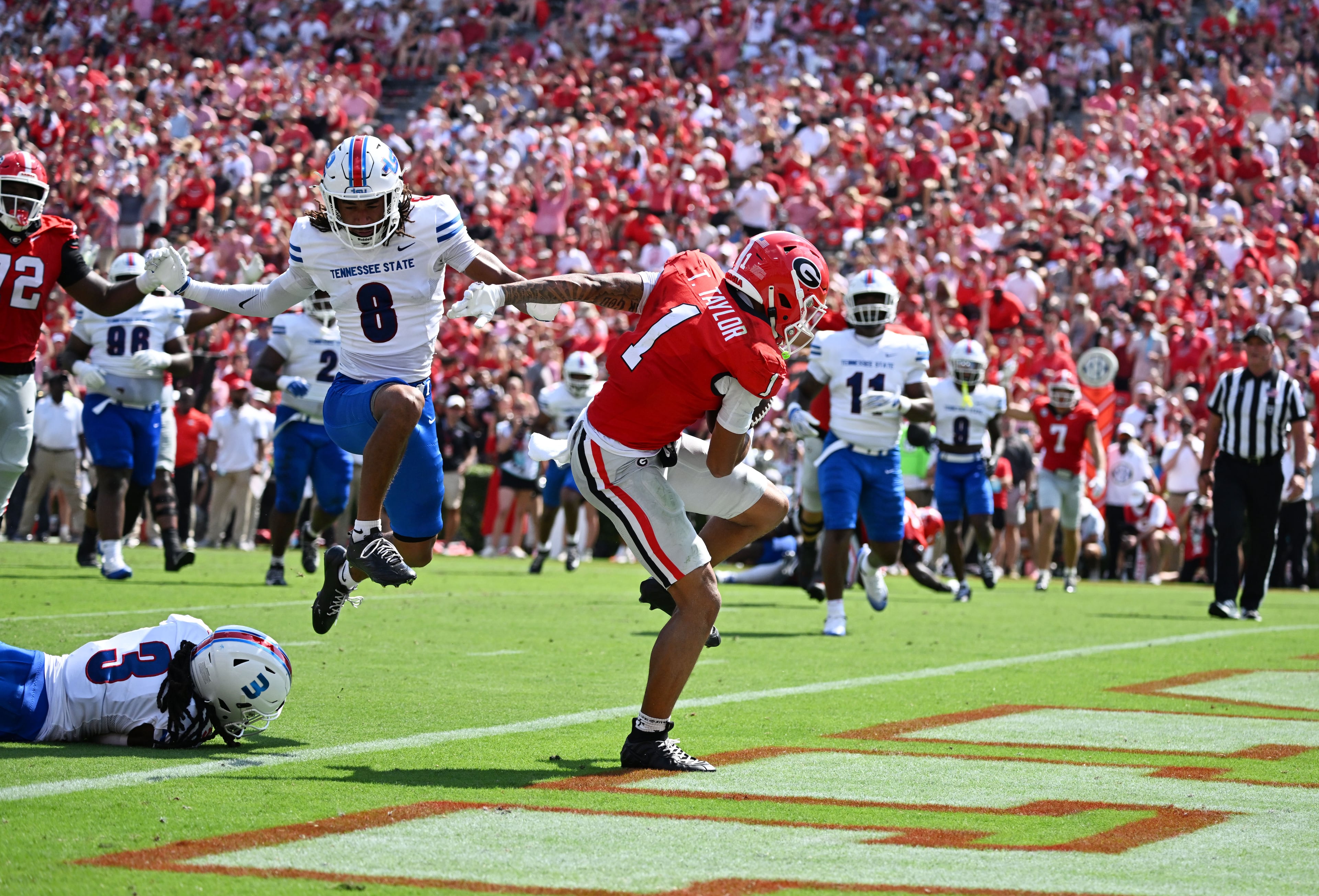 Georgia wide receiver Talyn Taylor runs past Tennessee State defensive back Mikeece Jones (bottom left) for a touchdown during the first half in an NCAA football game at Sanford Stadium on Saturday, Sept. 5, 2026, in Athens, Ga. (Hyosub Shin/AJC)