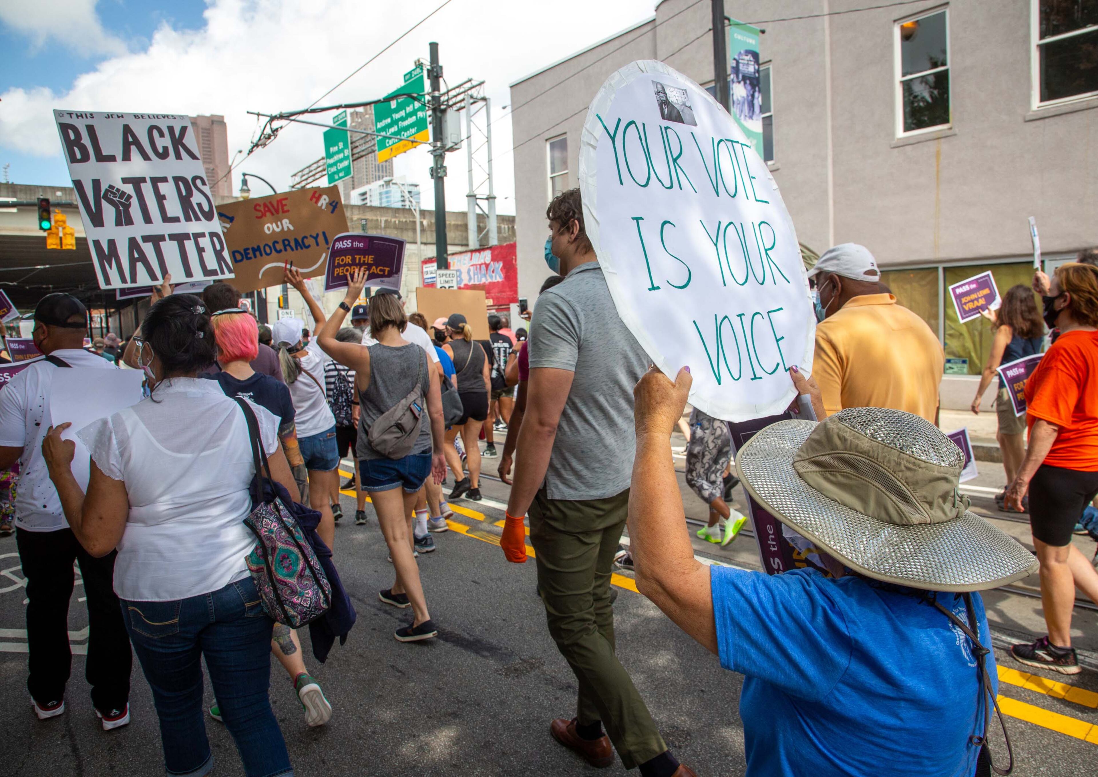 The March On For Voting Rights heads down Auburn Avenue towards the John Lewis mural in Atlanta on Saturday, August 28, 2021. STEVE SCHAEFER FOR THE ATLANTA JOURNAL-CONSTITUTION