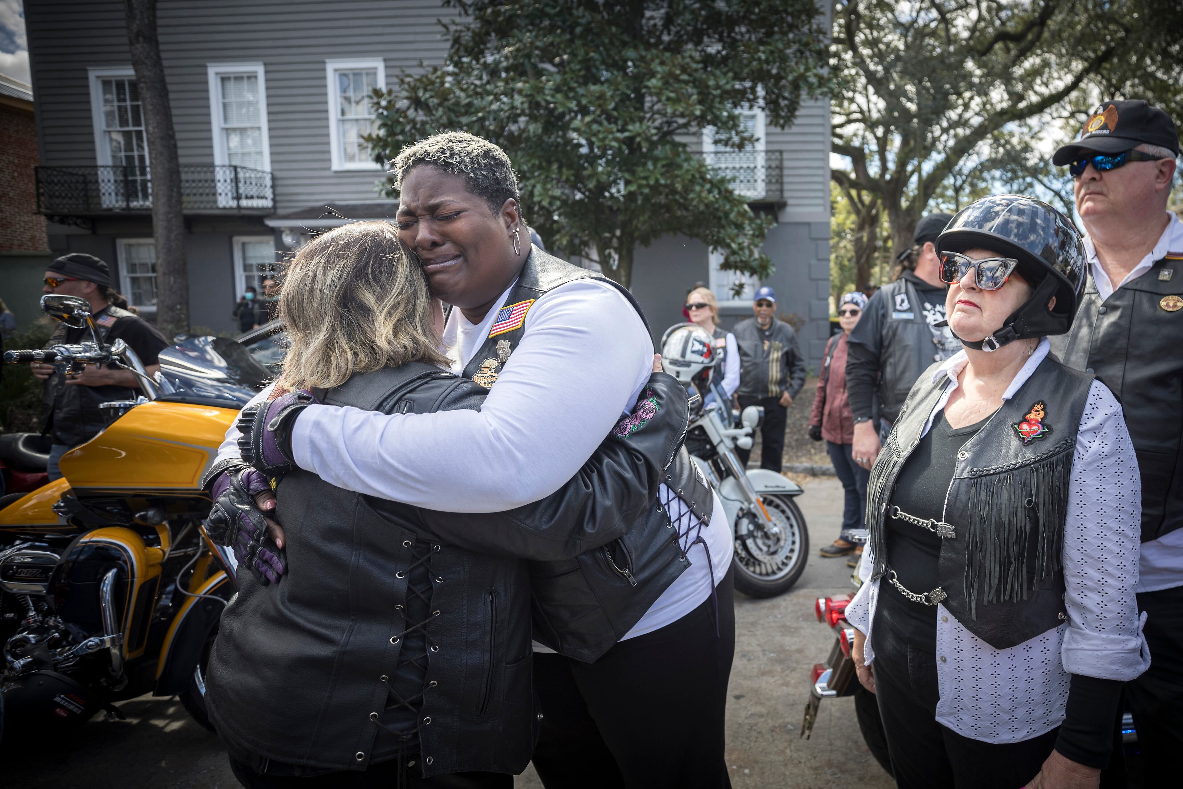Dana Fisher, a member of the American Legion Riders Post 184 hugs a fellow rider outside Campbell and Sons Funeral Home after the remains of U.S. Army Reservist Sgt. Breonna Moffett were brought inside, Thursday, Feb. 15, 2024, Savannah, Ga. Moffett was killed in a drone attack in January along with two other U.S. servicemen in Jordan. (AJC Photo/Stephen B. Morton)