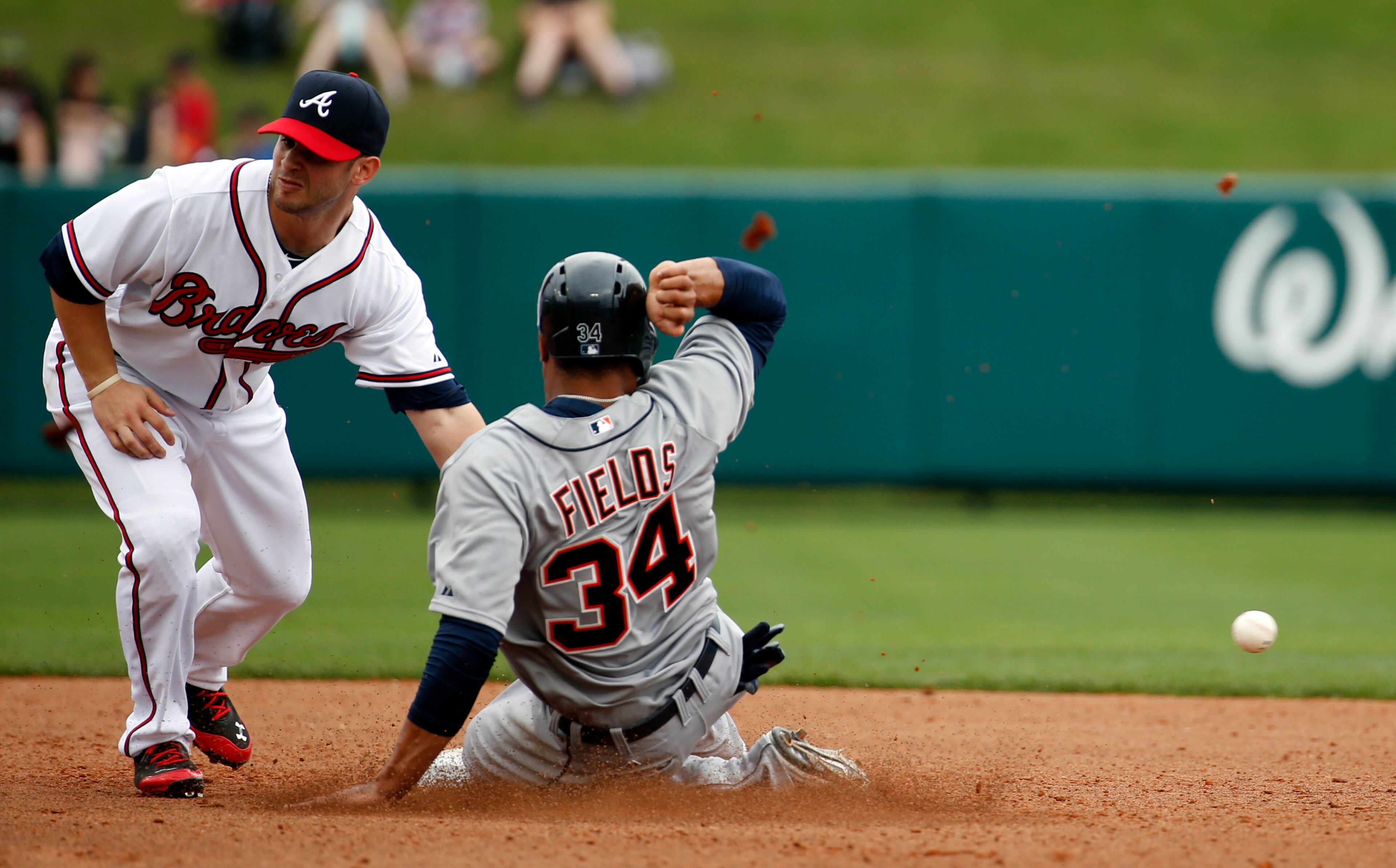 Detroit Tigers' Daniel Fields (34) is safe at second base as Atlanta Braves second baseman Tommy La Stella cannot handle the throw in the seventh inning of a spring exhibition baseball game on Wednesday, Feb. 26, 2014, in Kissimmee, Fla. The Tigers won 6-5. (AP Photo/Alex Brandon)