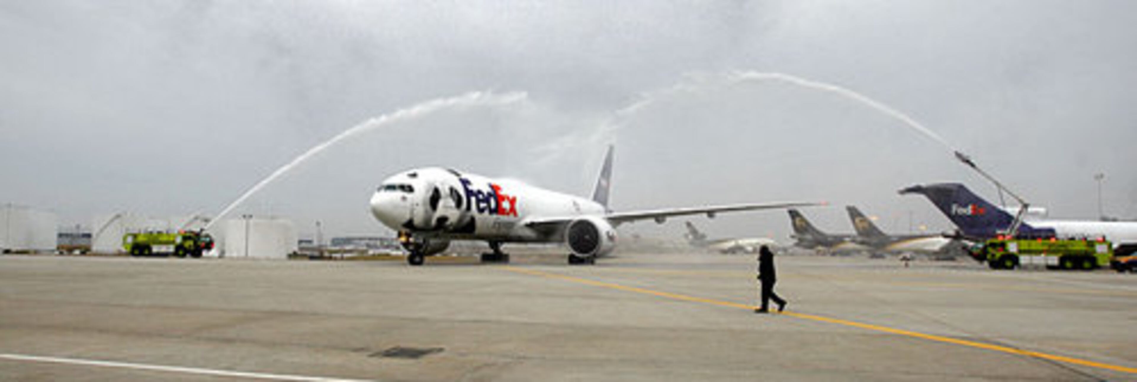 The Atlanta Fire Rescue crash trucks sent off the giant cargo plane with two arches of streaming water as a salute and farewell.