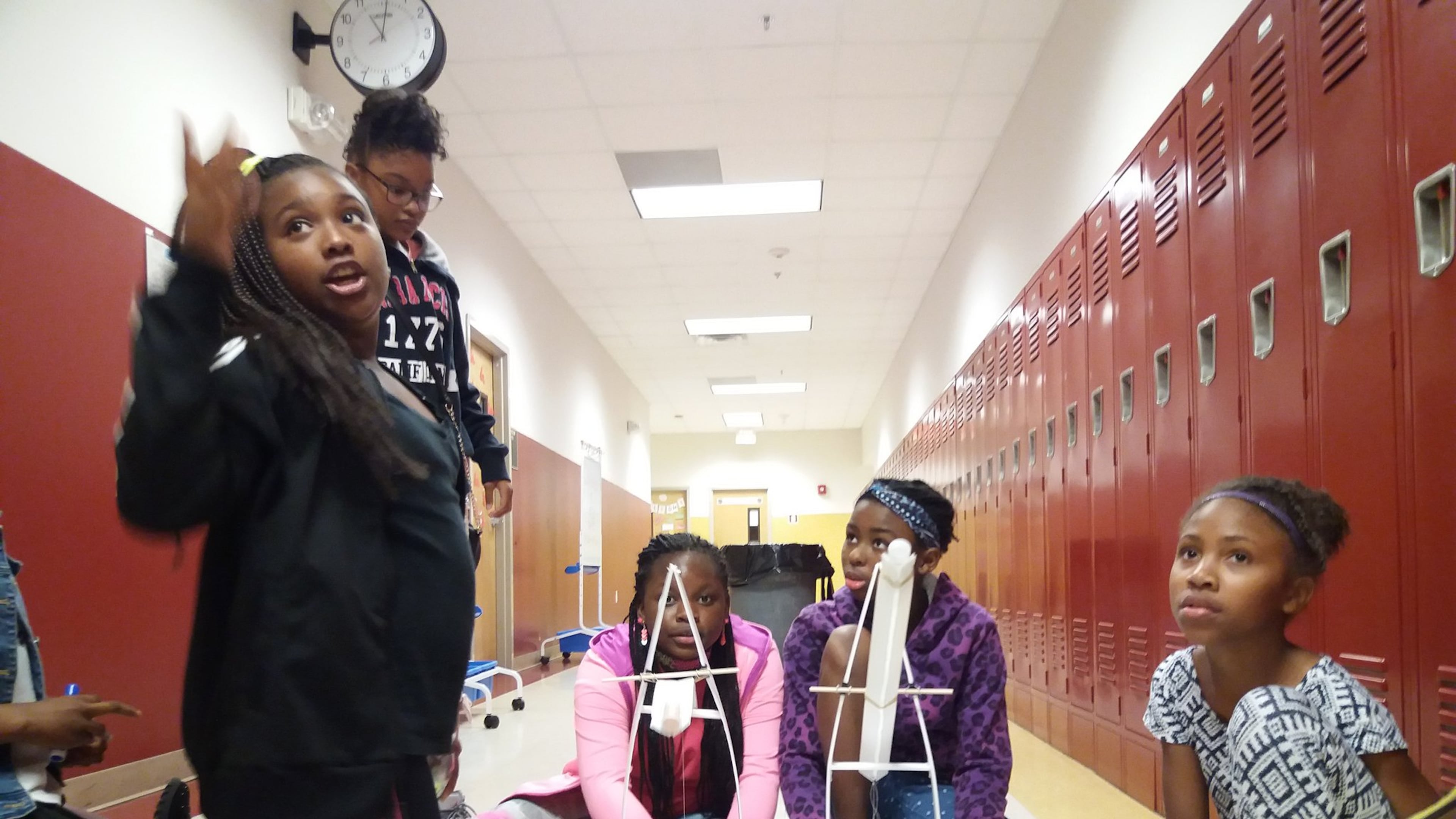 Makenzie Tucker, Zola Stewart, Miracle Williams, Cassidy White, and Kennedi Williams, students in the Summer Engineering Experience for Kids ready their gravity cruiser — a cart powered by weights pulling a string — for testing. Girls around metro Atlanta participated in a summer program that encourages African-American students to develop an early interest in engineering. The free program is one of 16 nationwide sponsored by the National Society of Black Engineers