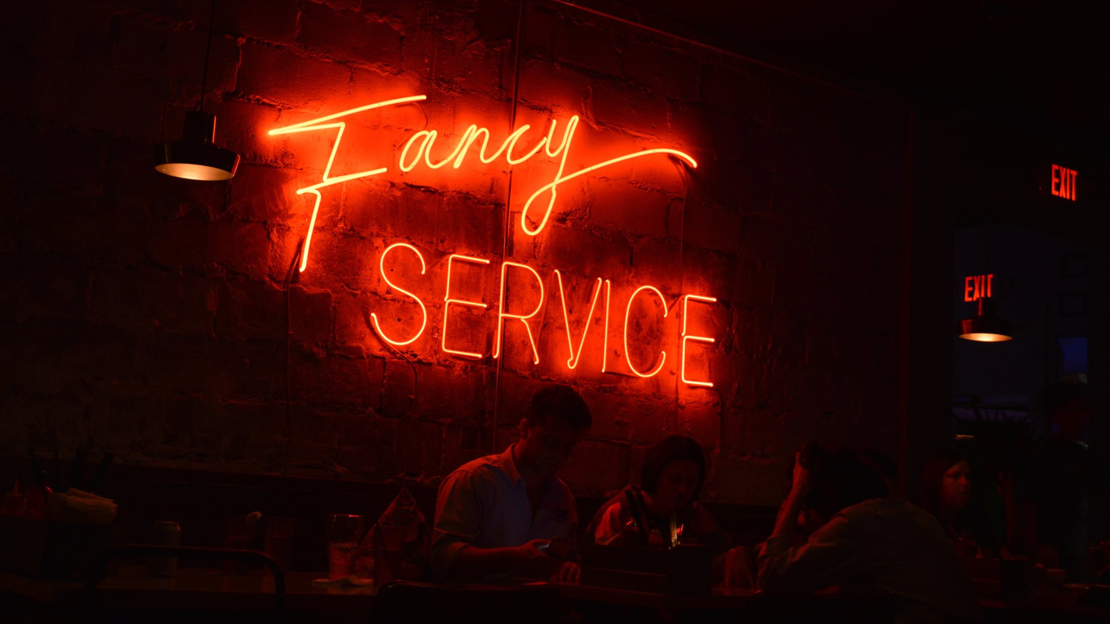 Bon Ton’s main dining room features a large neon sign reading “Fancy Service.” (Henri Hu