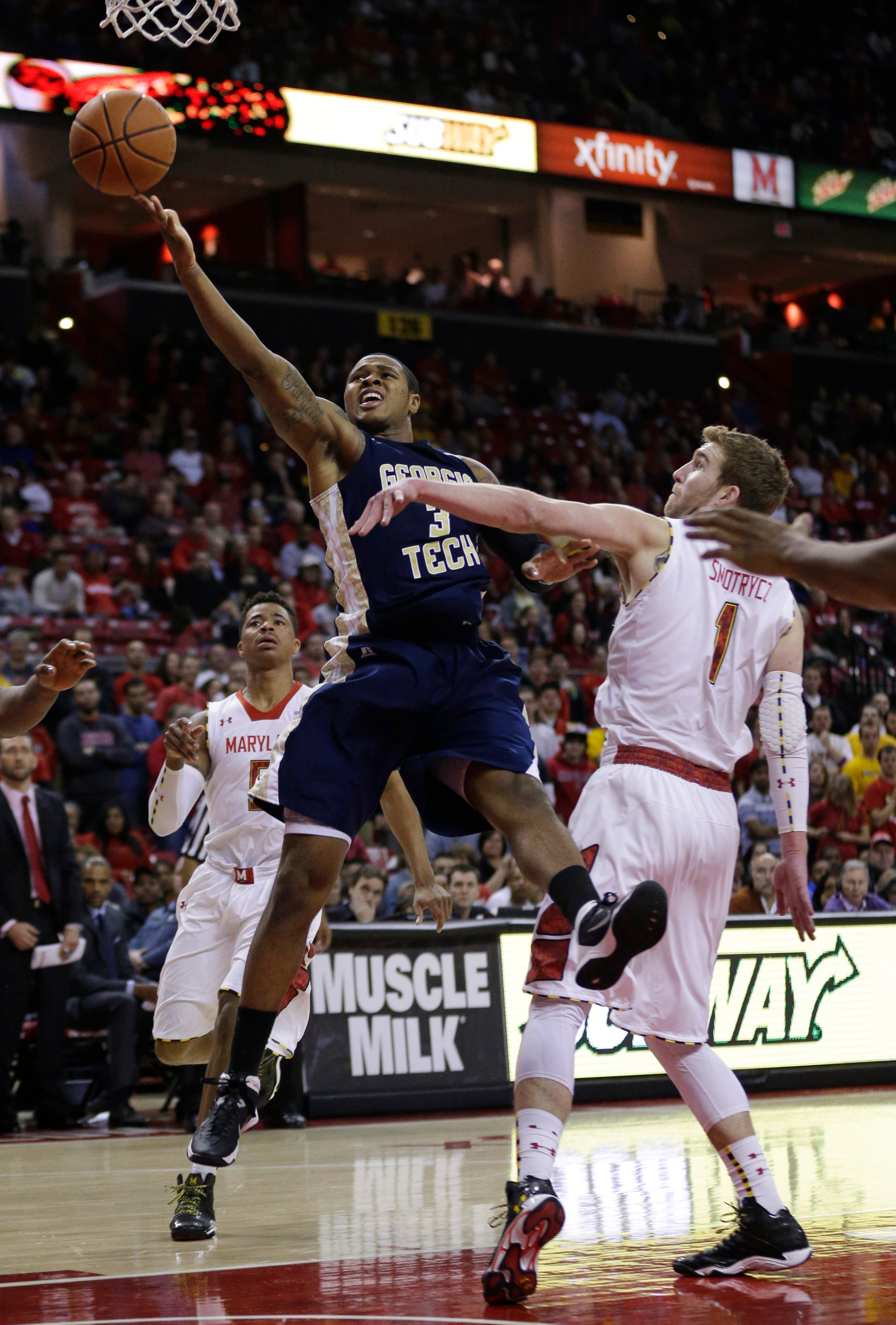 Georgia Tech guard/forward Marcus Georges-Hunt, center, goes up for a basket between Maryland guard Nick Faust, back left, and forward Evan Smotrycz in the first half of an NCAA college basketball game in College Park, Md., Saturday, Jan. 4, 2014. Maryland won 77-61, despite a team-high 11 points from Georges-Hunt.