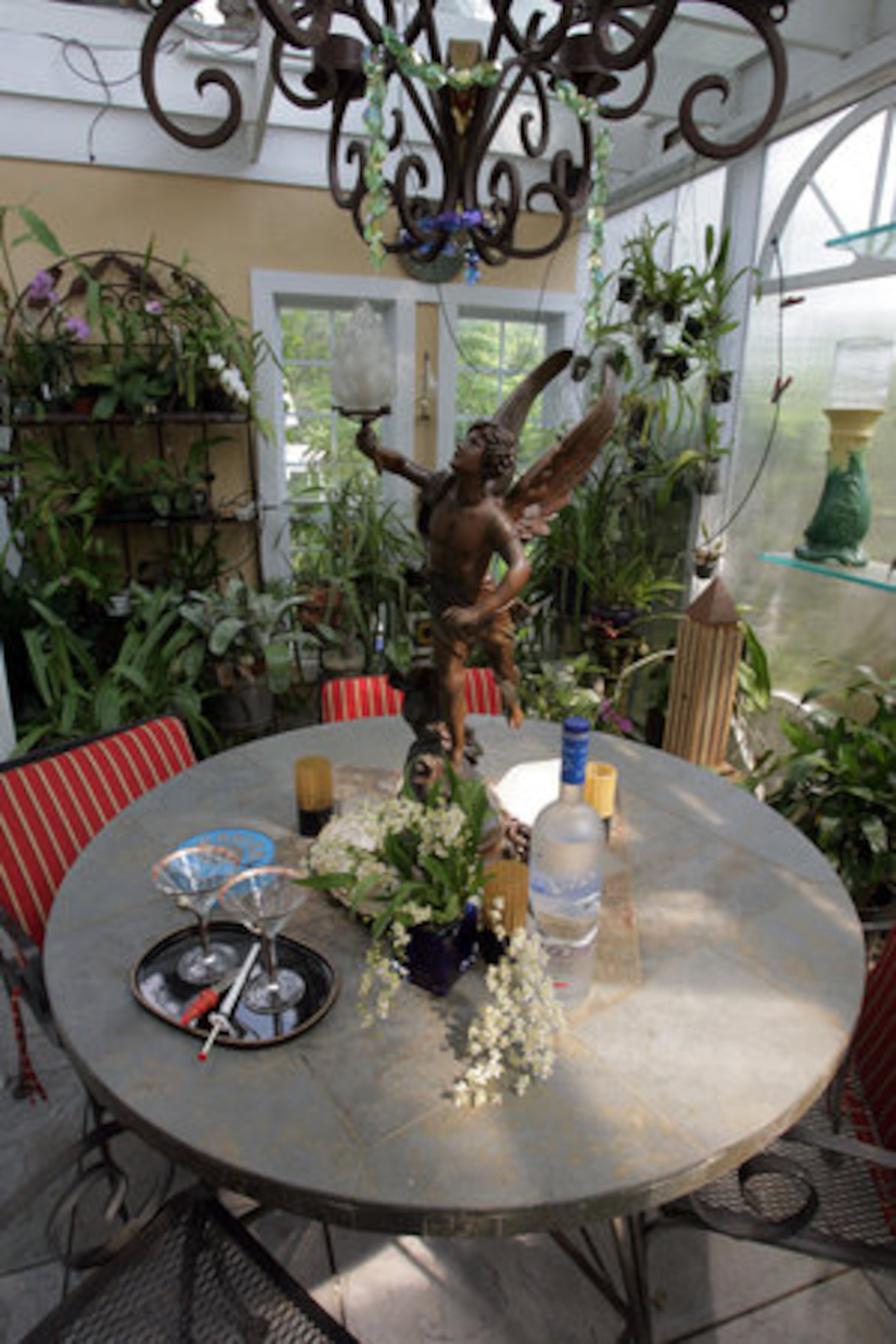 Martini glasses are always at the ready inside this garden space. The tabletop statue and chandelier are among the treasures McPherson and Brown have found over the years.