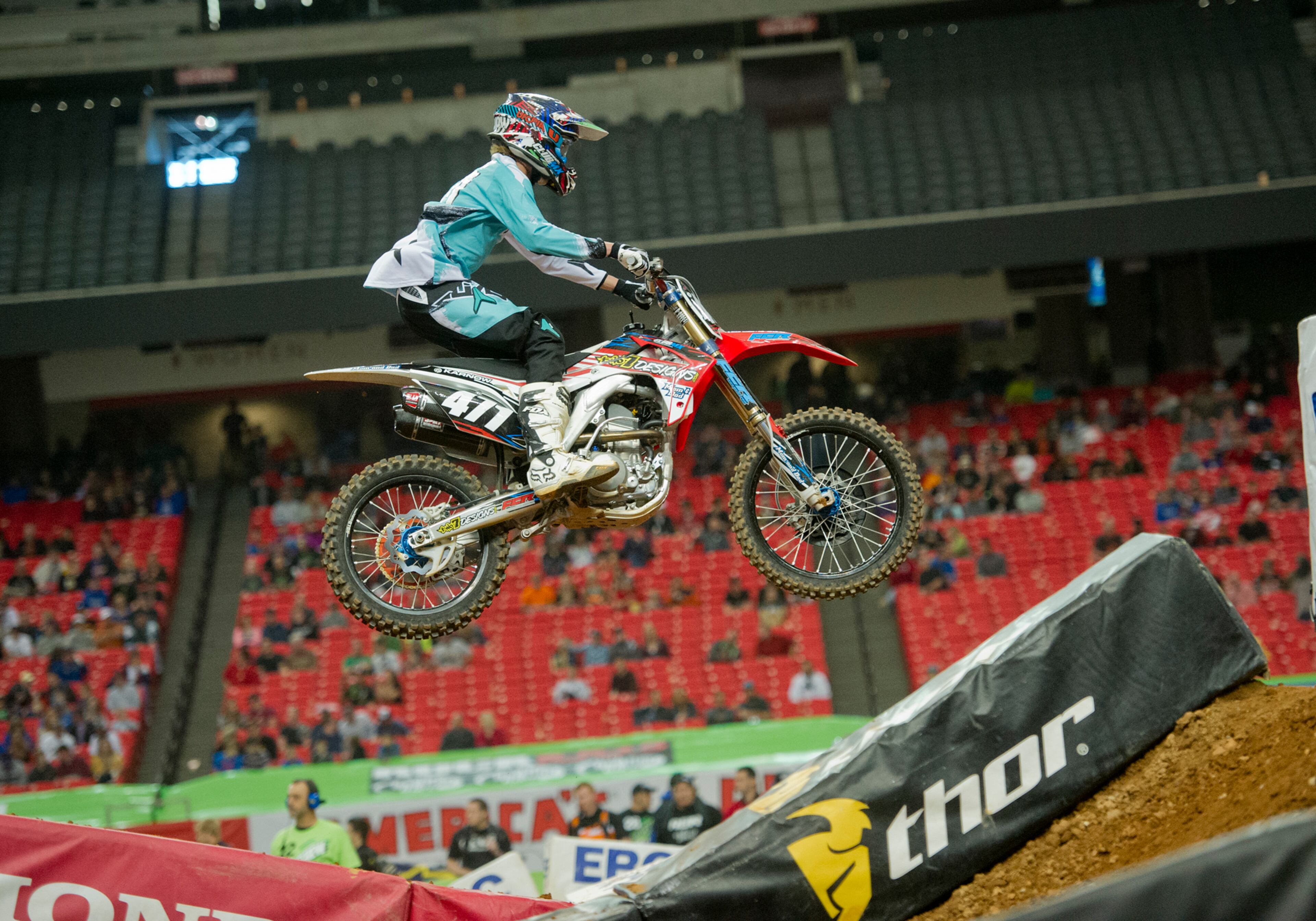 Logan Karnow (471) catches some air as he competes in a qualifying round of the Monster Energy AMA Supercross FMI World Championship at the Georgia Dome in Atlanta on Saturday, February 22, 2014.