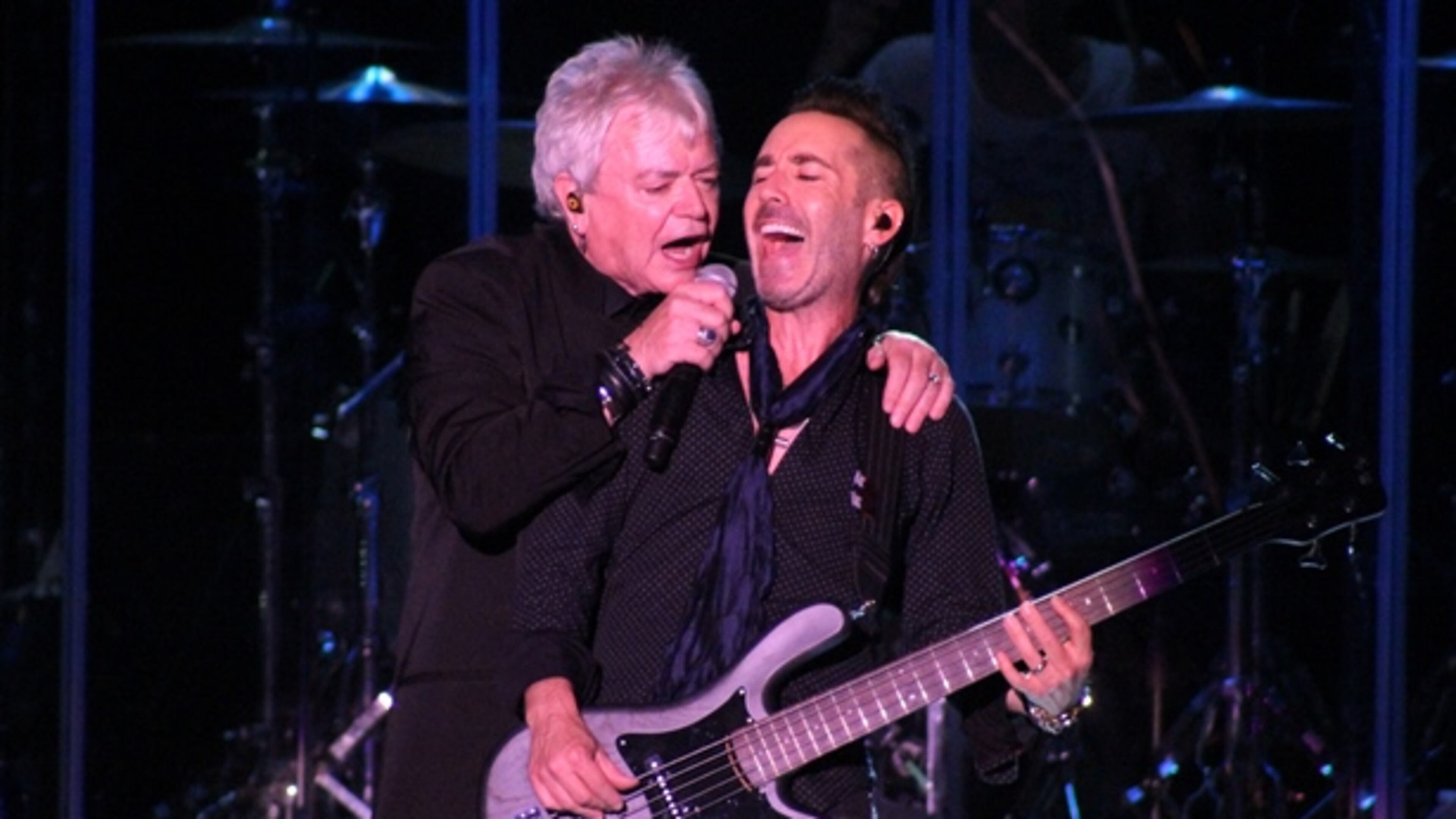 Air Supply's Russell Hitchcock and bassist Derek Frank share a moment during Friday's concert at Chastain. Photo: Melissa Ruggieri/AJC