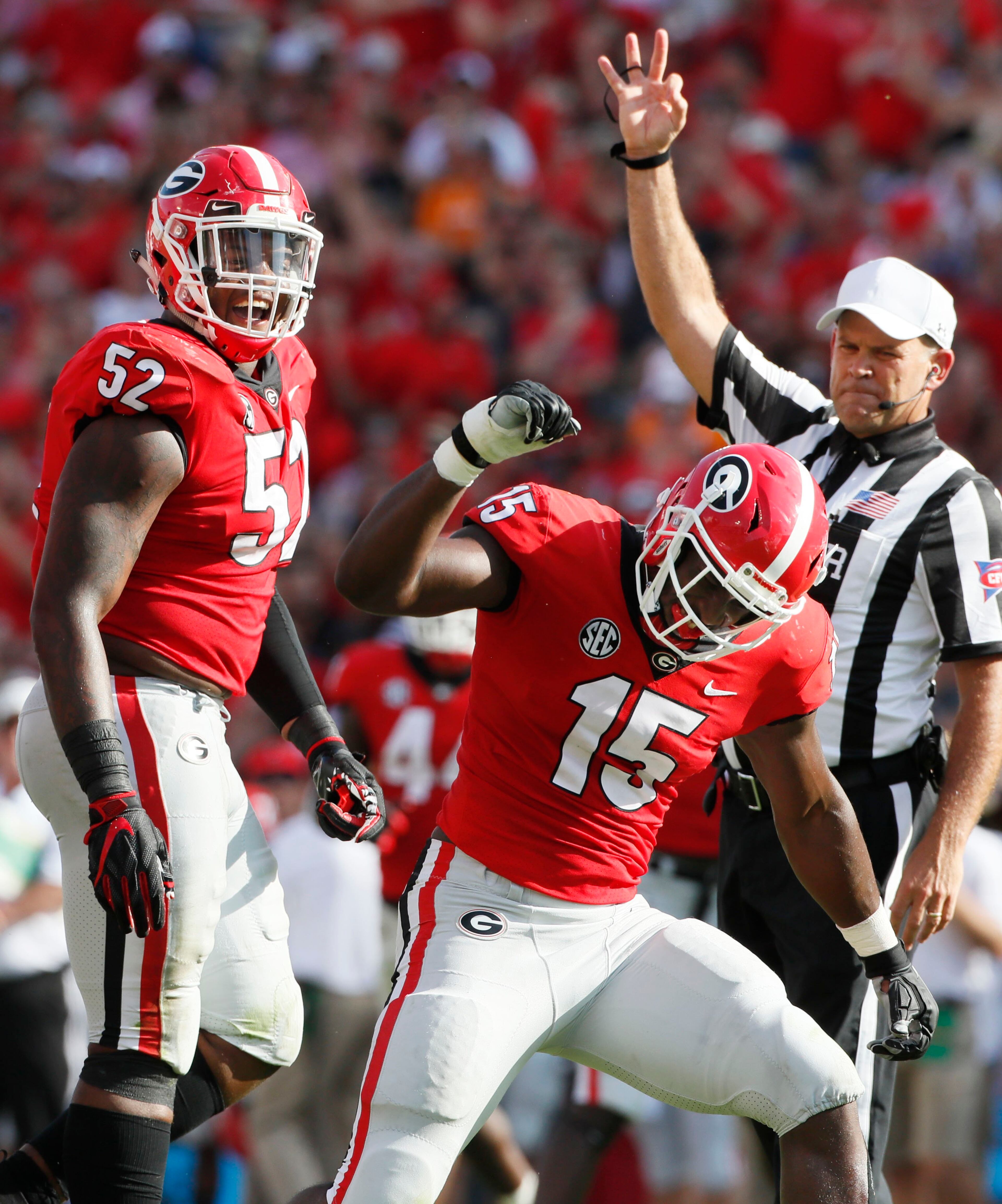 Georgia Bulldogs defensive lineman Tyler Clark (52) and Georgia Bulldogs linebacker D'Andre Walker (15) celebrate Walker's sack of Tennessee Volunteers quarterback Jarrett Guarantano (2) in the first half. The University of Georgia Bulldogs played the Tennessee Volunteers in a NCAA college football game Saturday, Sept 29, 2018, at Sanford Stadium in Athens, GA. BOB ANDRES /BANDRES@AJC.COM