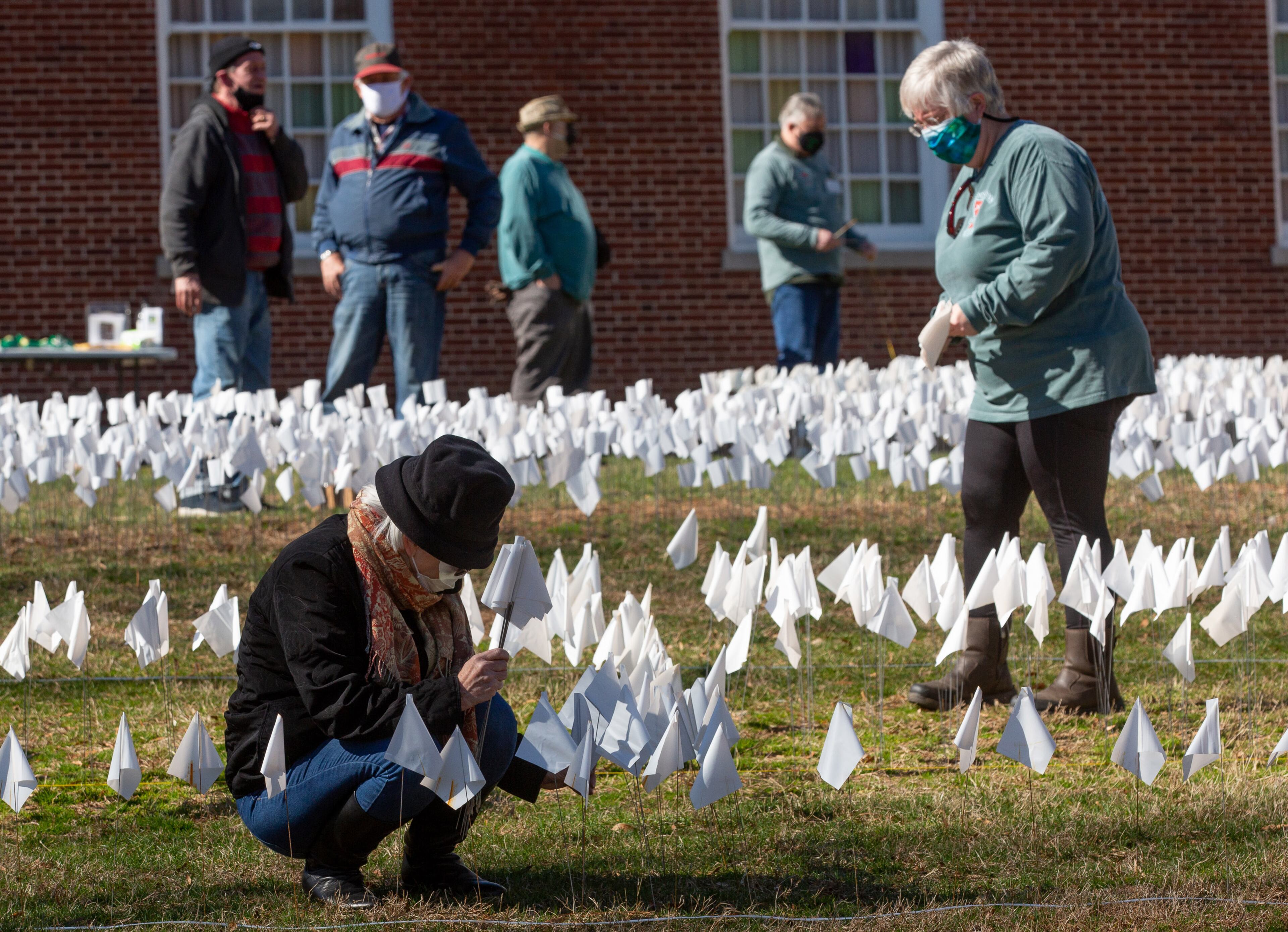 Volunteers plant some of the 15,000 flags on the lawn of First Christian Church of Decatur on Saturday, February 20, 2021. The flags represent the number of COVID-19 deaths in Georgia, and the effort aims to raise awareness about the toll of the coronavirus. (Photo: Steve Schaefer for The Atlanta Journal-Constitution)