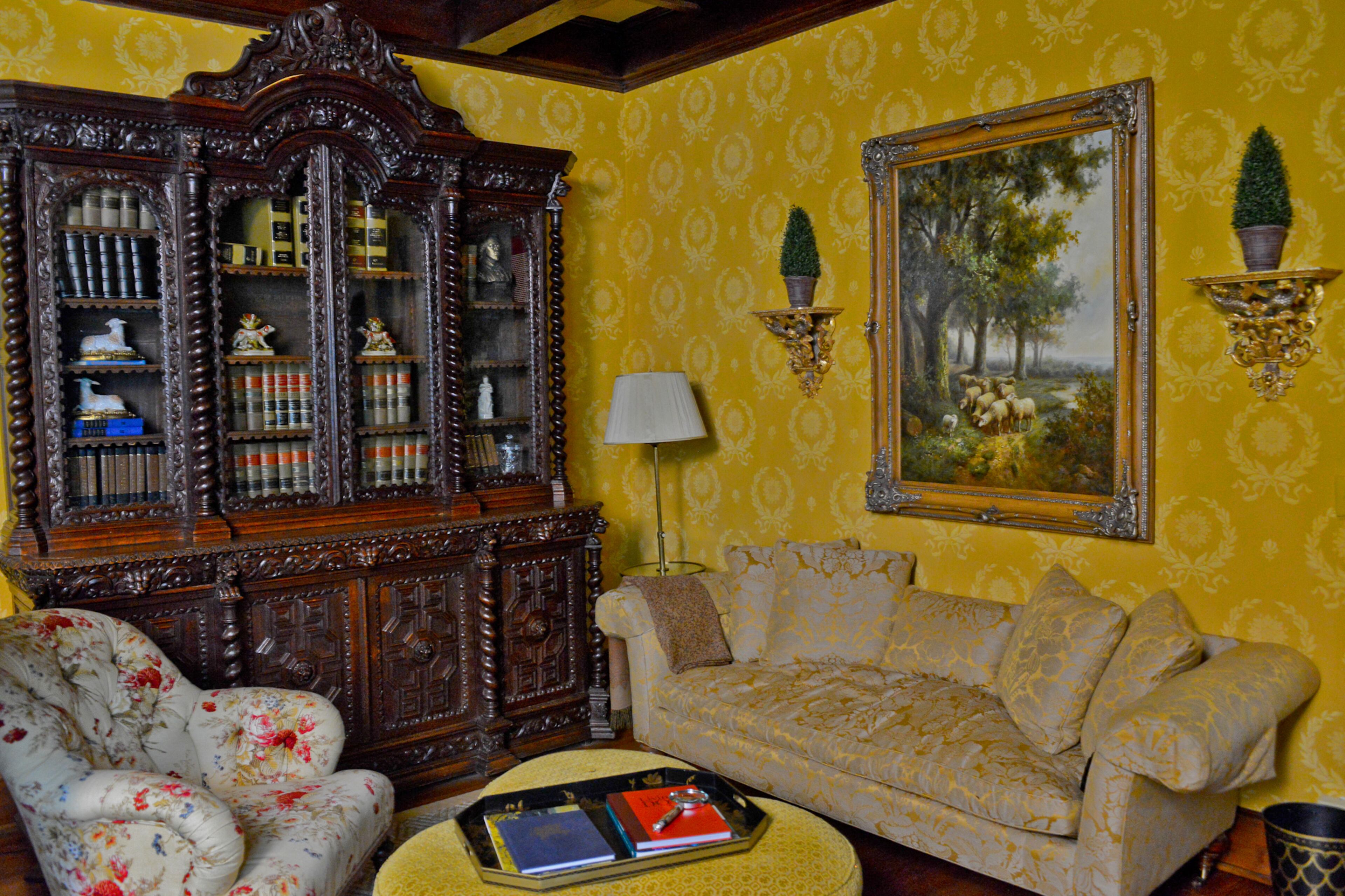 The 1900s Gothic-styled library bookcase in the living room is one of attorney Keenan Nix's favorite pieces of furniture in the house. He says the statement piece anchors the room and is a perfect balance to the large scale of the room and deeply coffered ceiling.