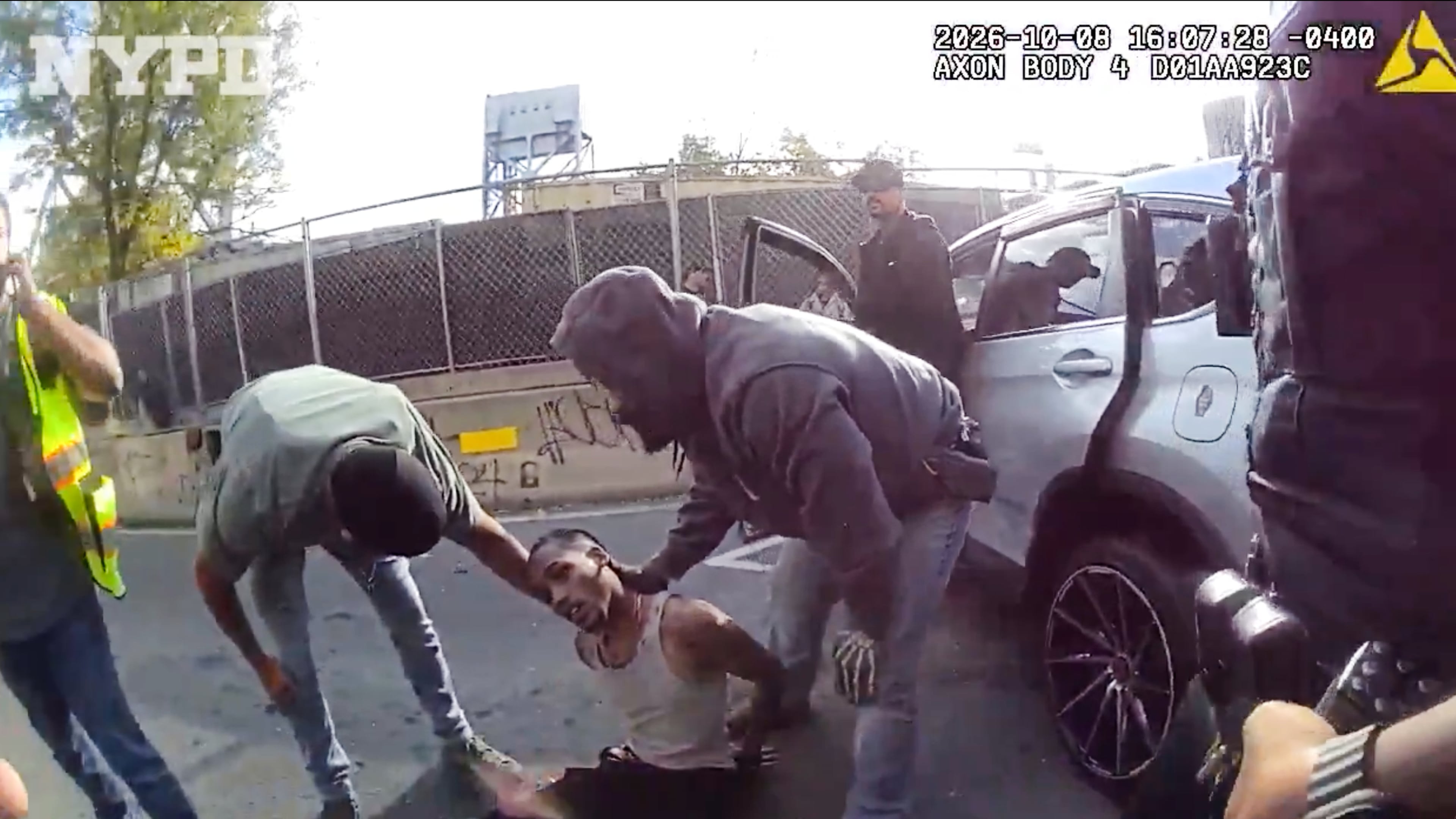In this image taken from police-worn body camera video released the New York City Police Department (NYPD), law enforcement personnel tend to a Oscar Belgal, 28, a Dominican man who was shot by Federal immigration officers, Thursday, Oct. 8, 2026, in New York, as he drove his car with a 5-year-old boy inside. (NYPD via AP)